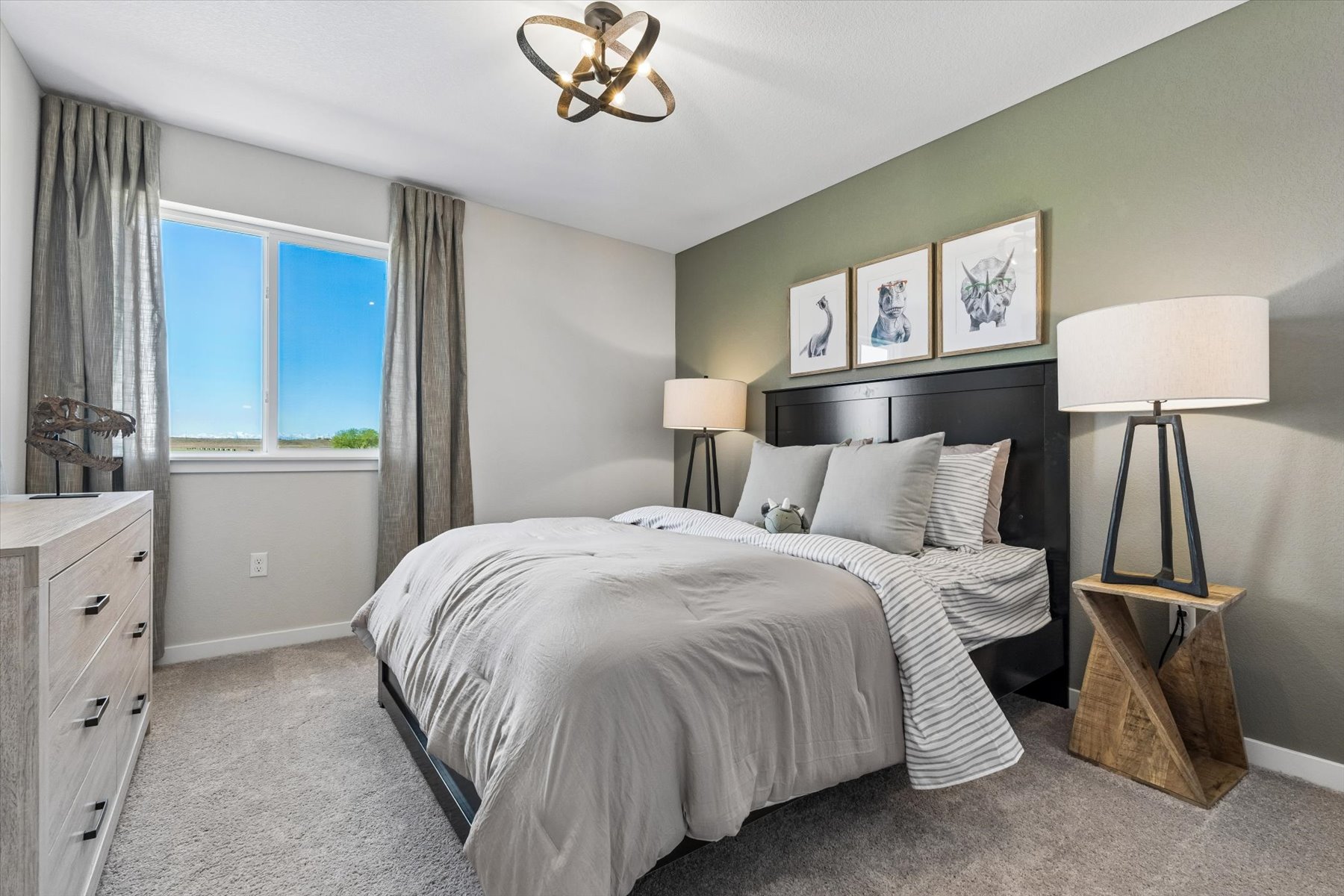 A bedroom with a bed and lamps.