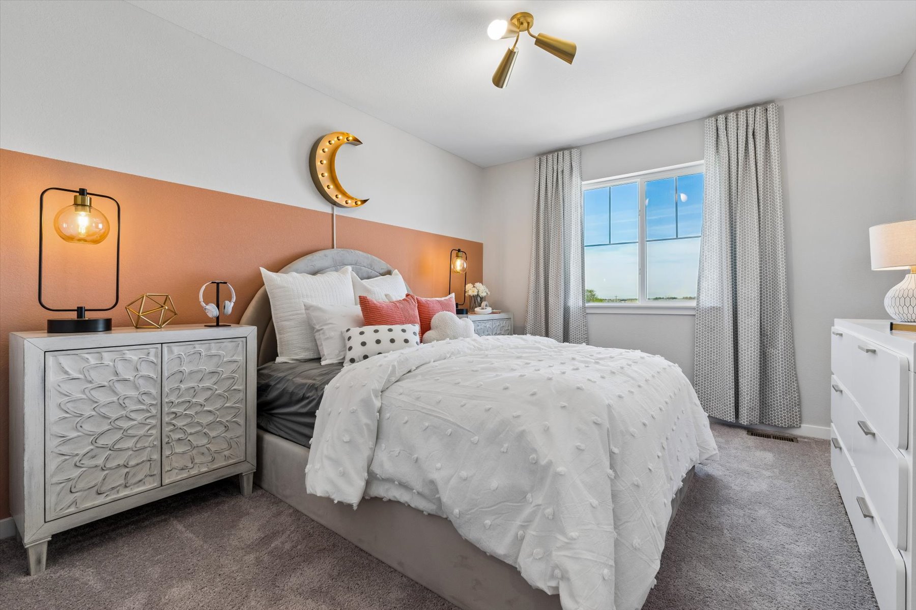 A bedroom with a bed and a dresser.