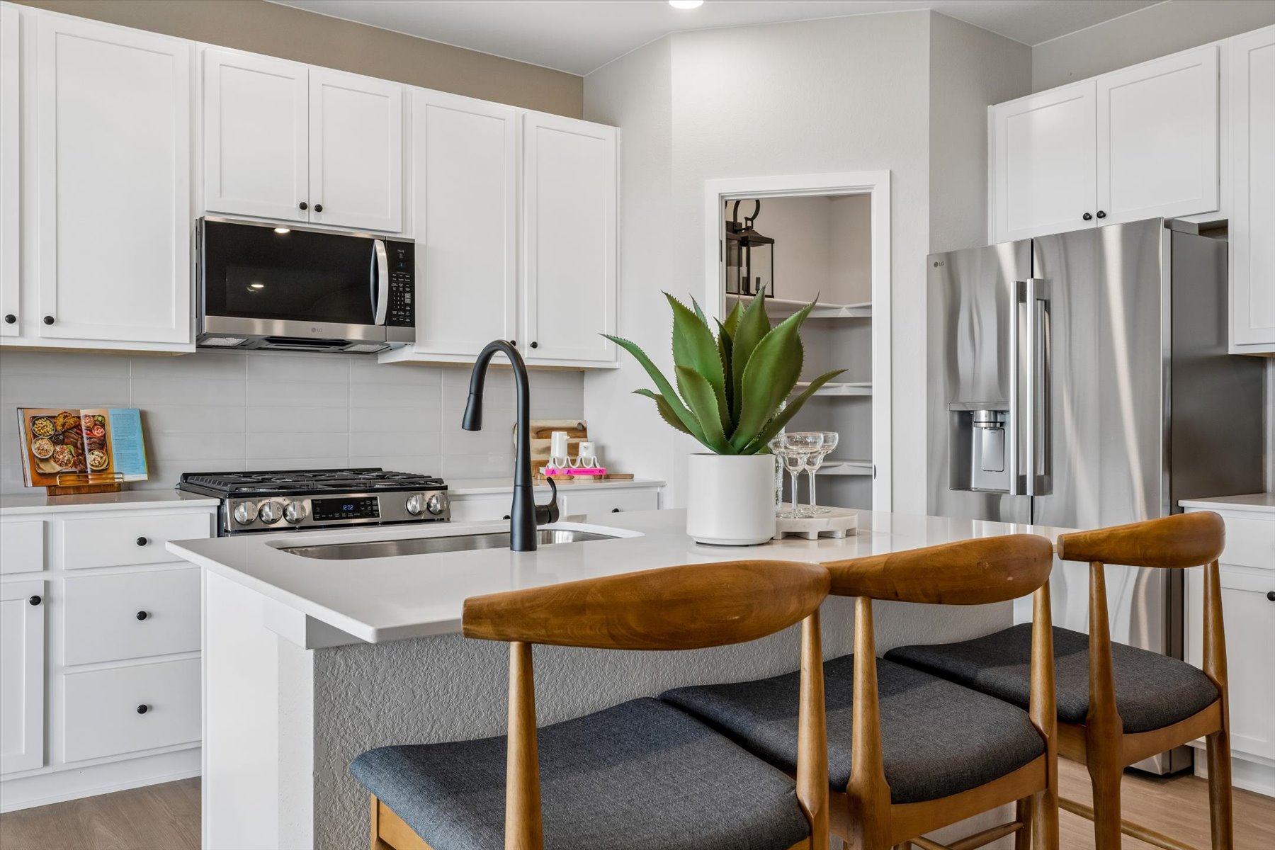 A kitchen with white cabinets.