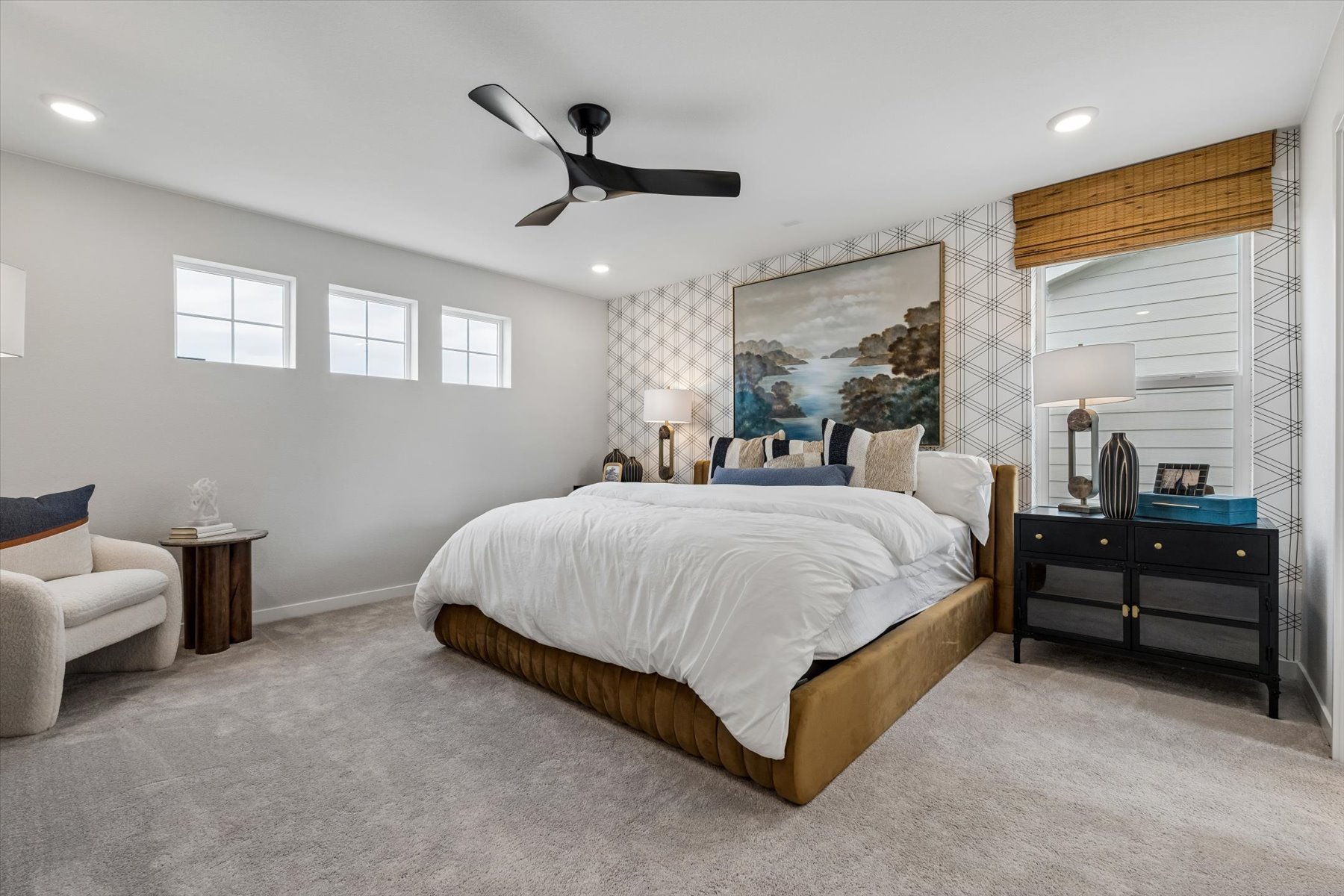 A bedroom with a bed and a chair.