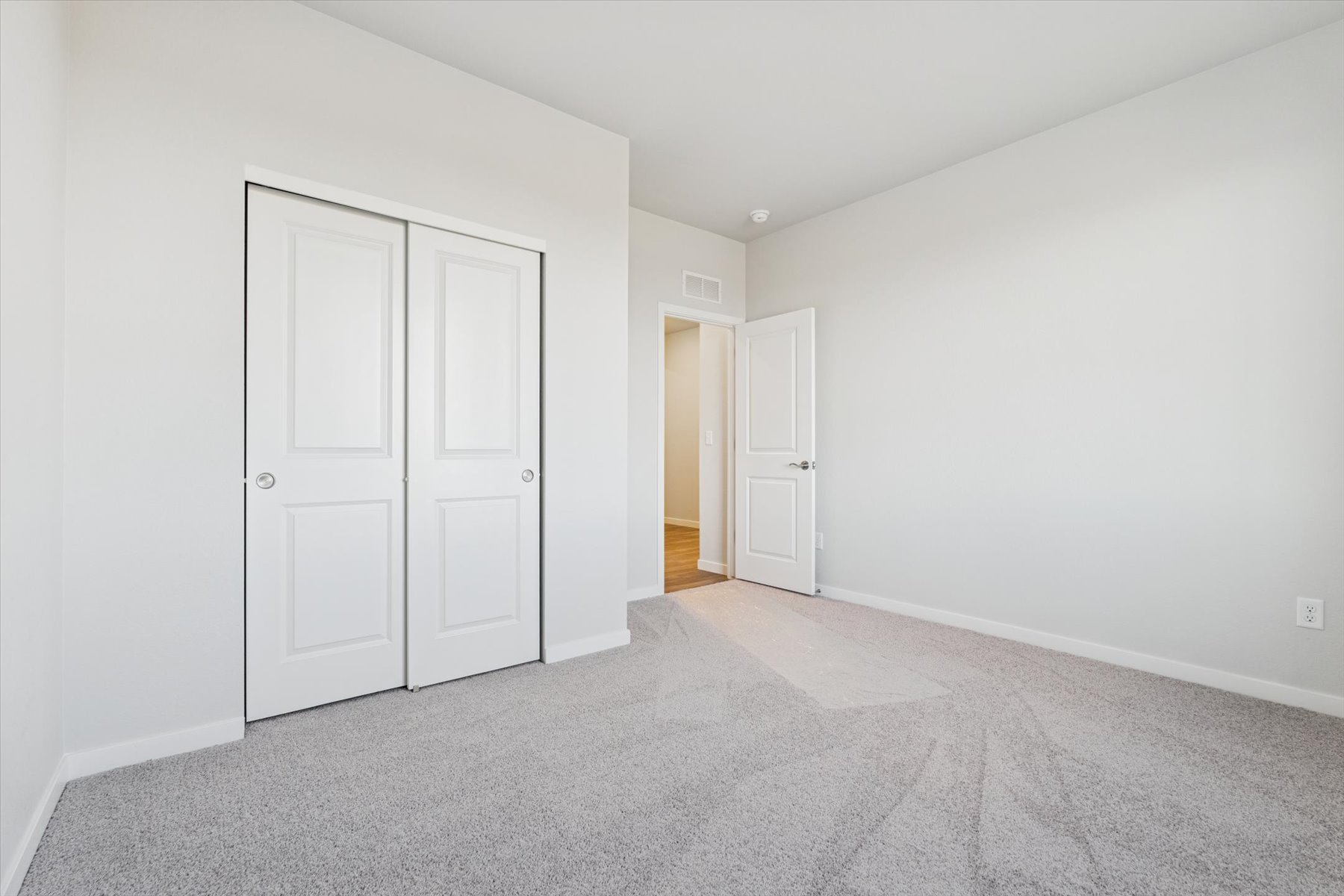 A hallway with white doors.
