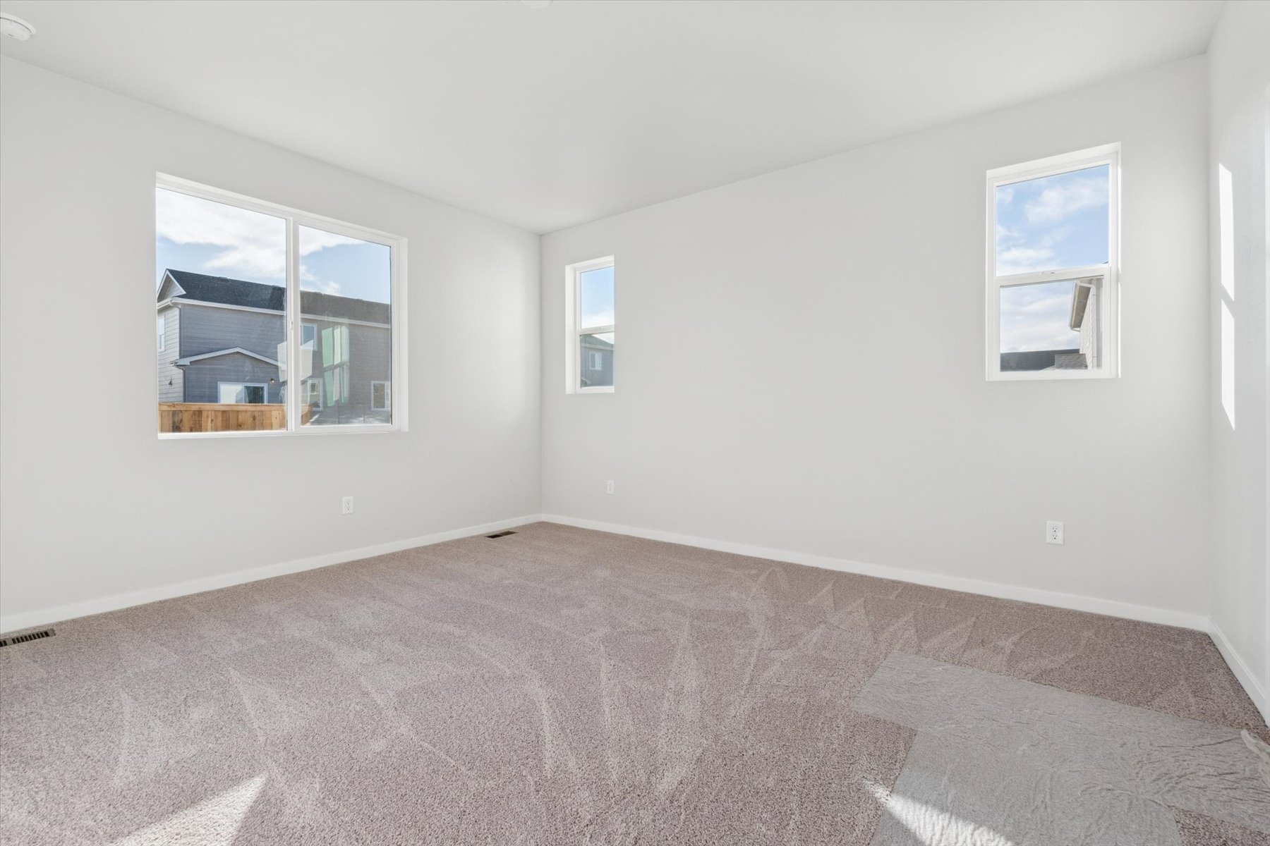 A room with a carpet and a rug.