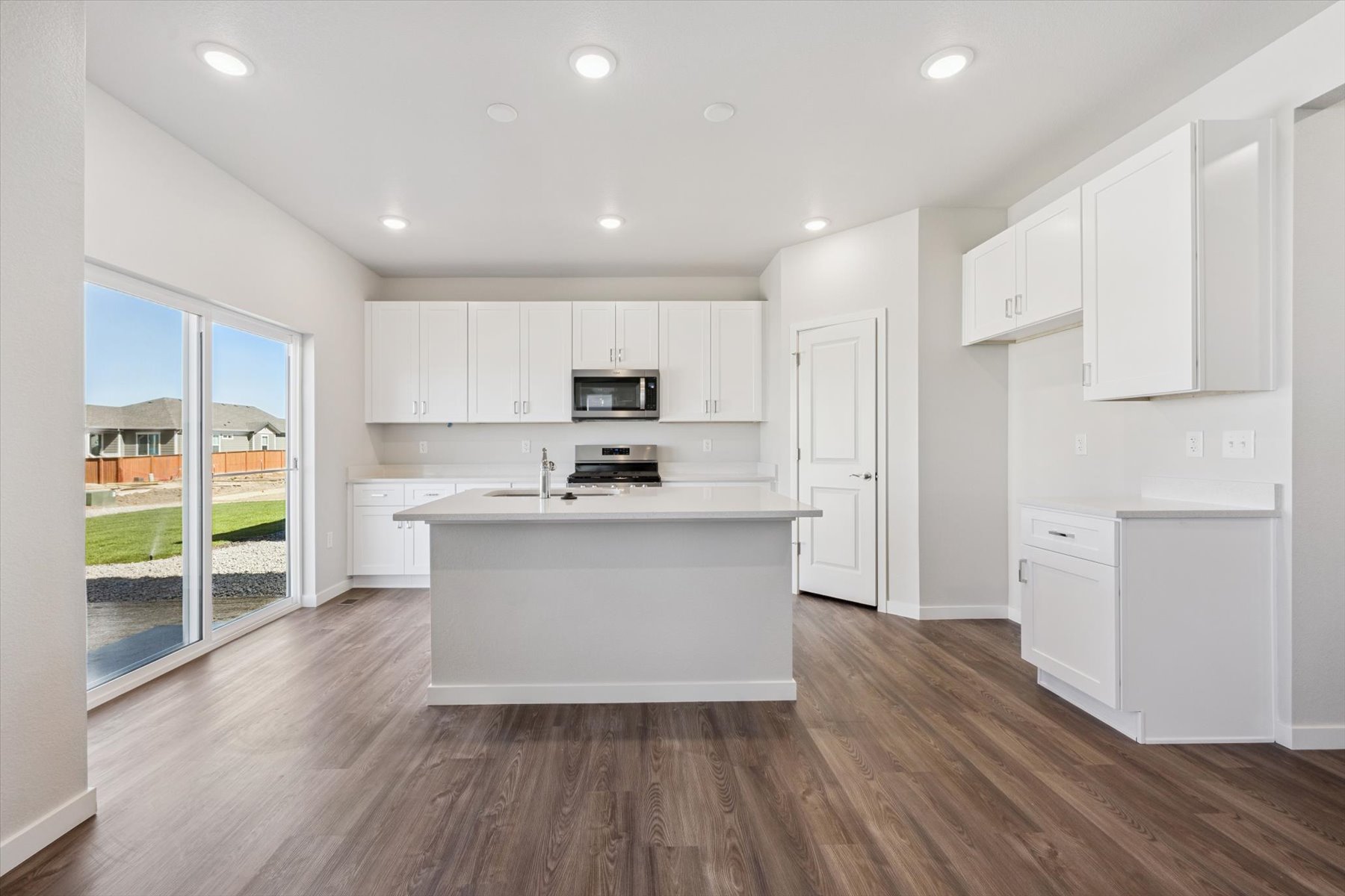 A kitchen with white cabinets.