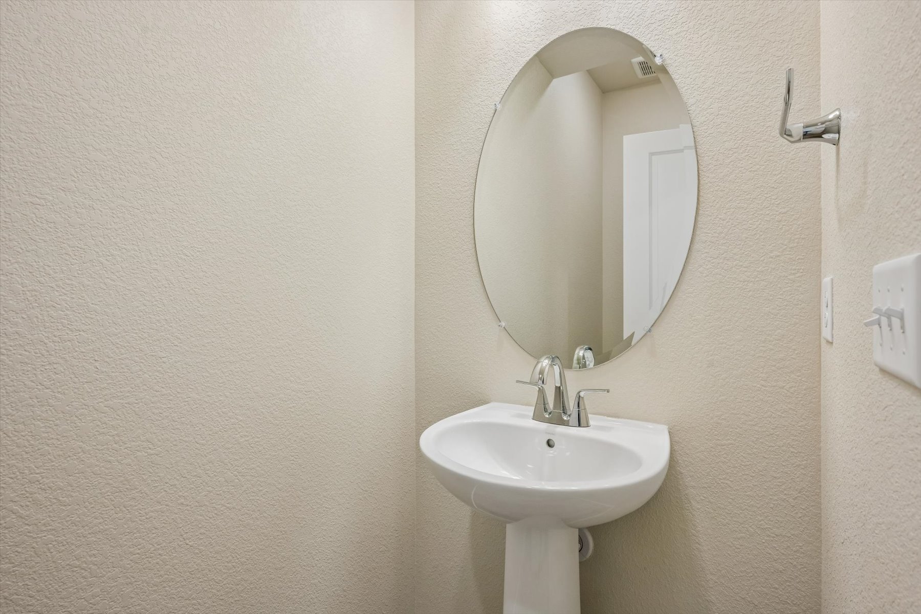 A mirror above a sink.