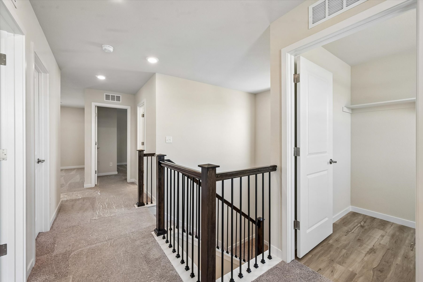 A hallway with white doors.