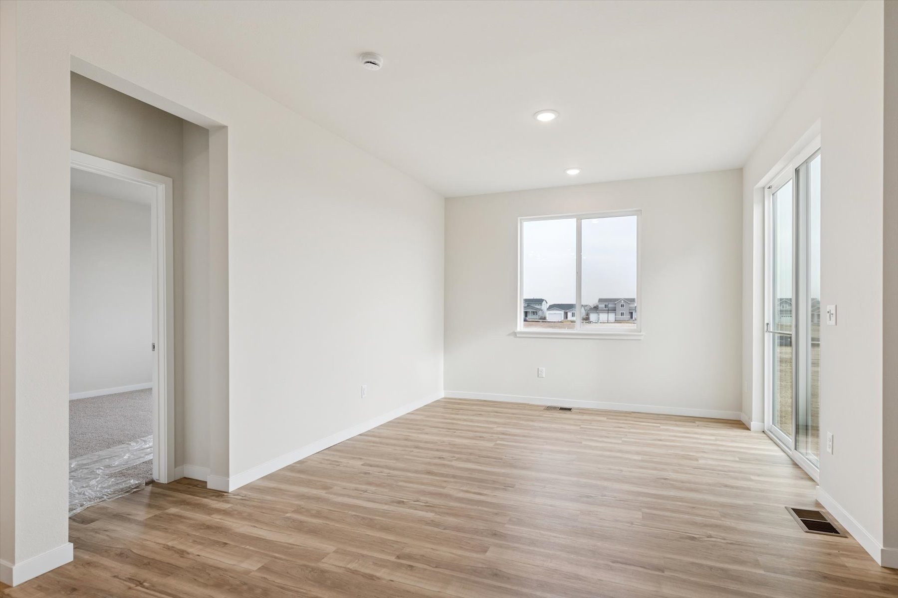 A room with a wood floor and white walls.