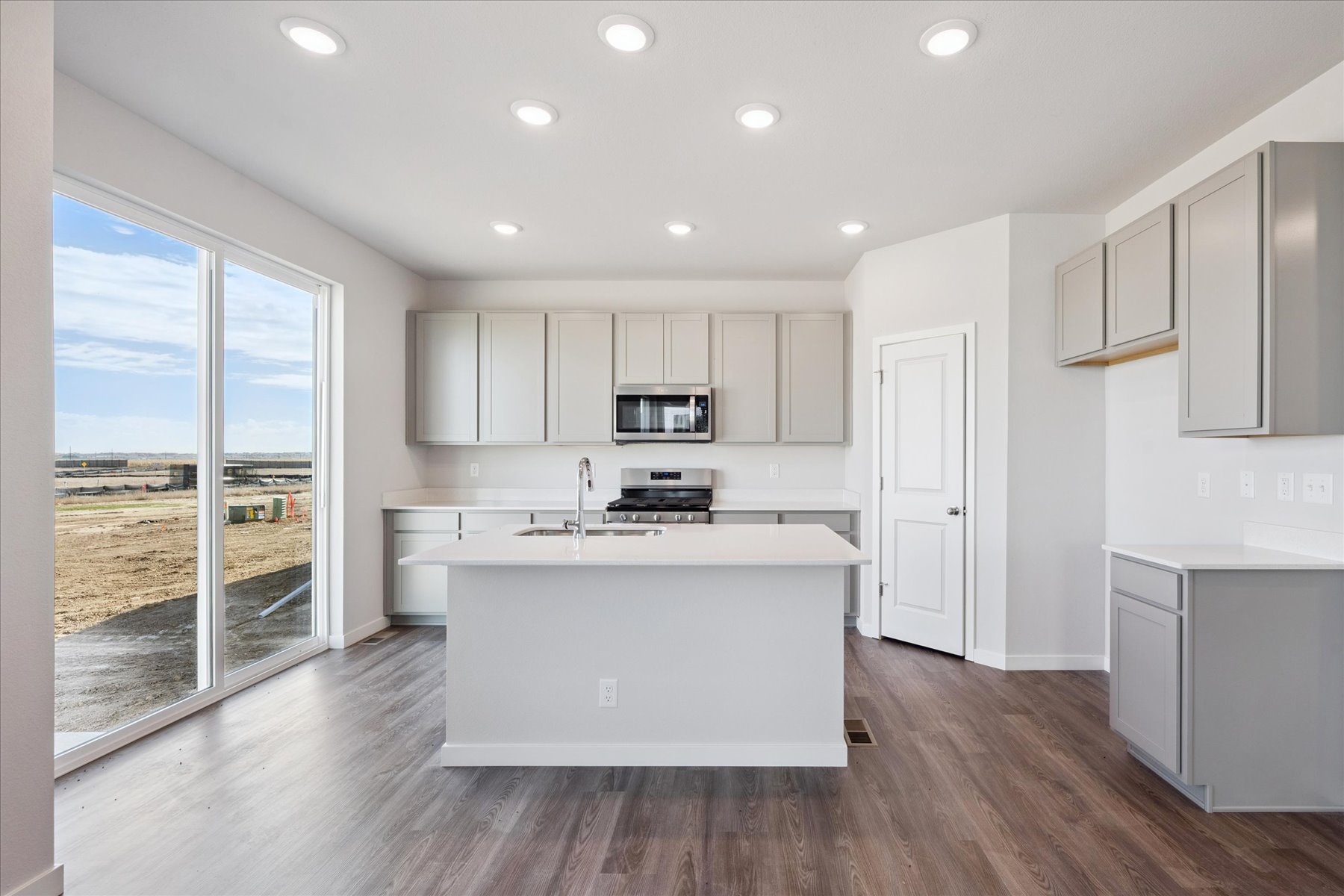 A kitchen with white cabinets.