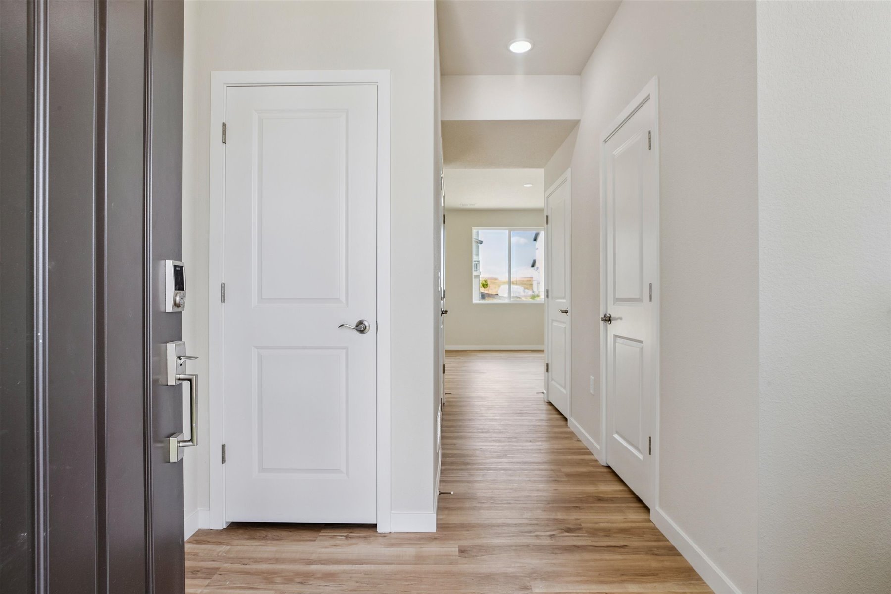 A hallway with white doors.