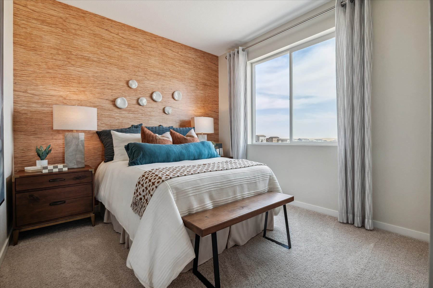 A bedroom with a bed and a table.