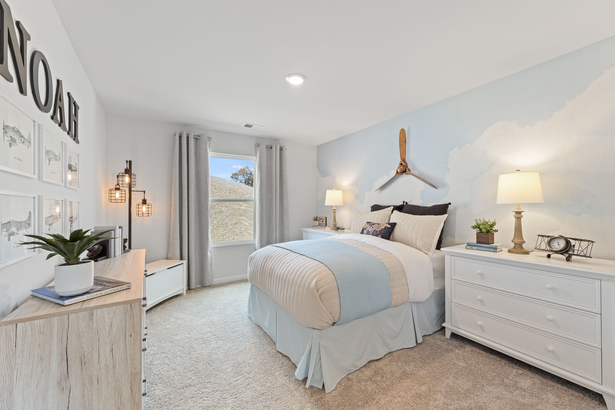 A bedroom with a bed and a window.