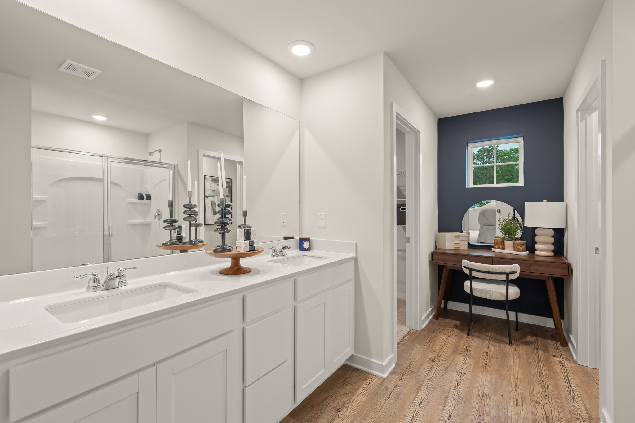 A bathroom with a tub sink and a mirror.