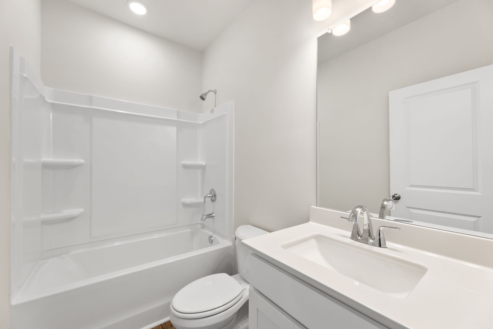 A bathroom with a tub sink and toilet.
