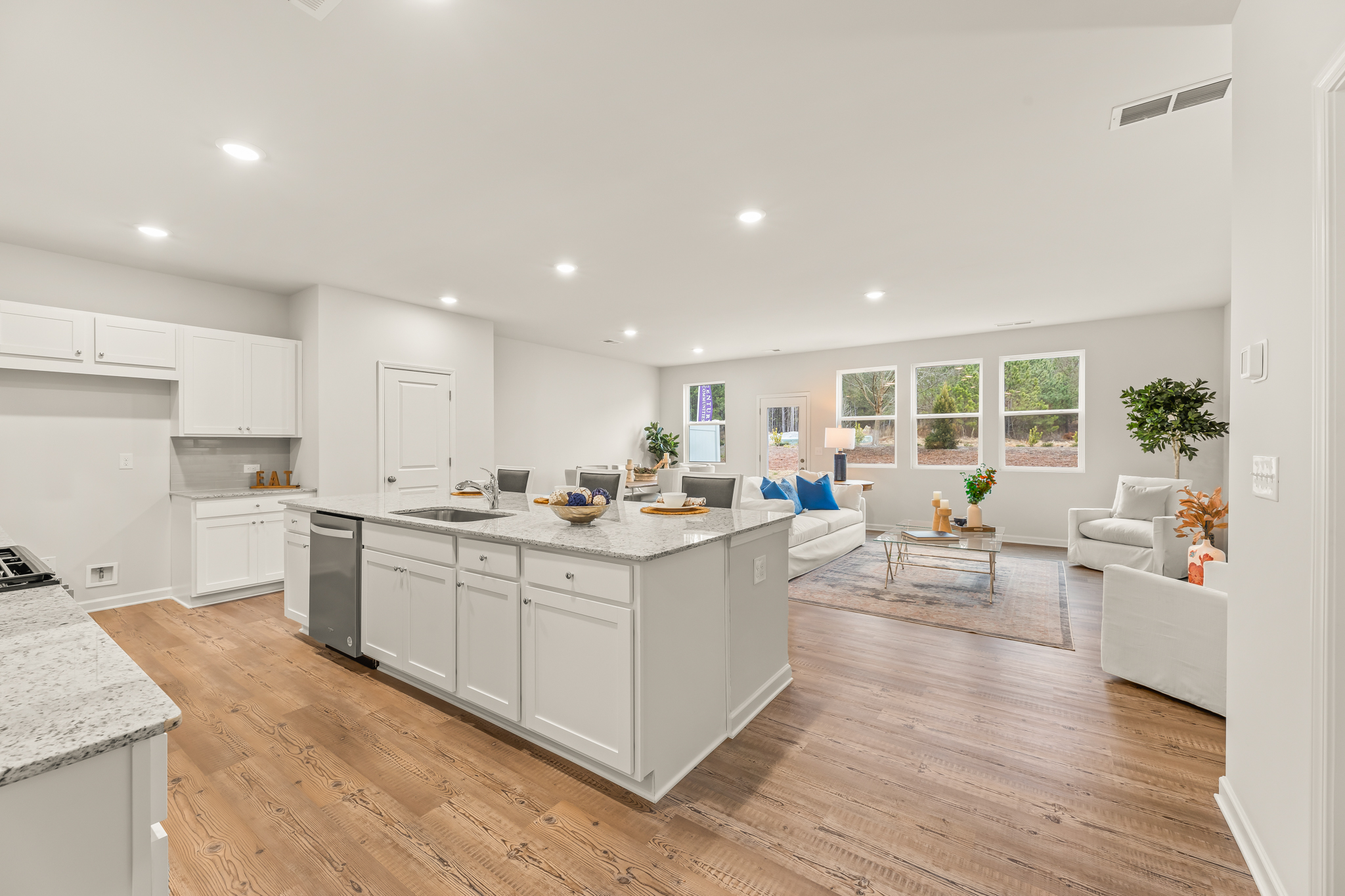 A large kitchen with a wood floor.
