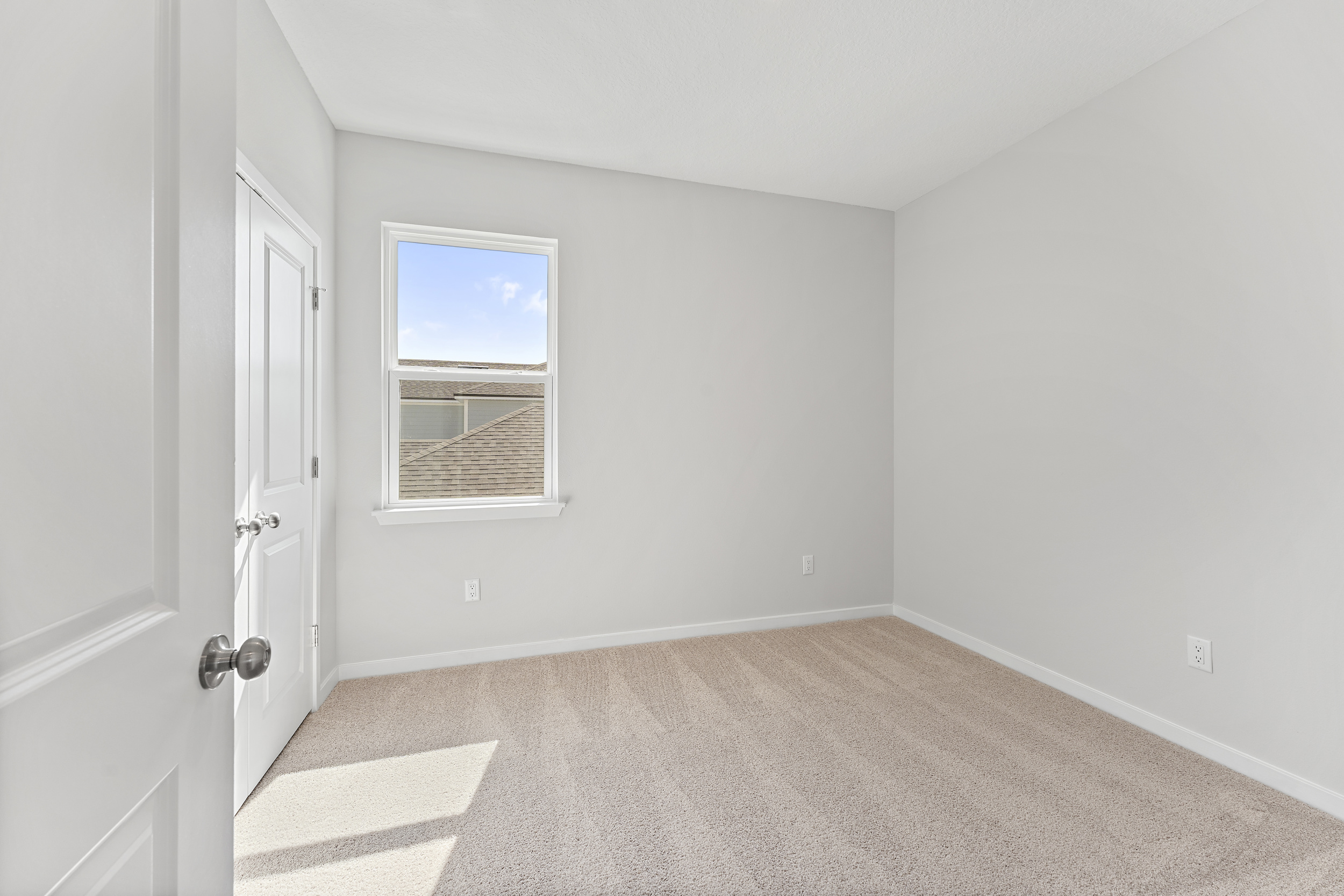 Lot 20 Ponderosa II Guest Bedroom with Window and Double Closet Doors at Camden Woods in Kingsland, GA