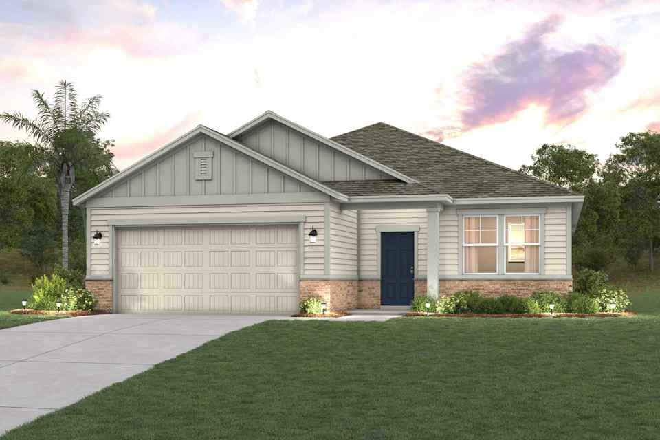 A house with a garage and a lawn in front of it.