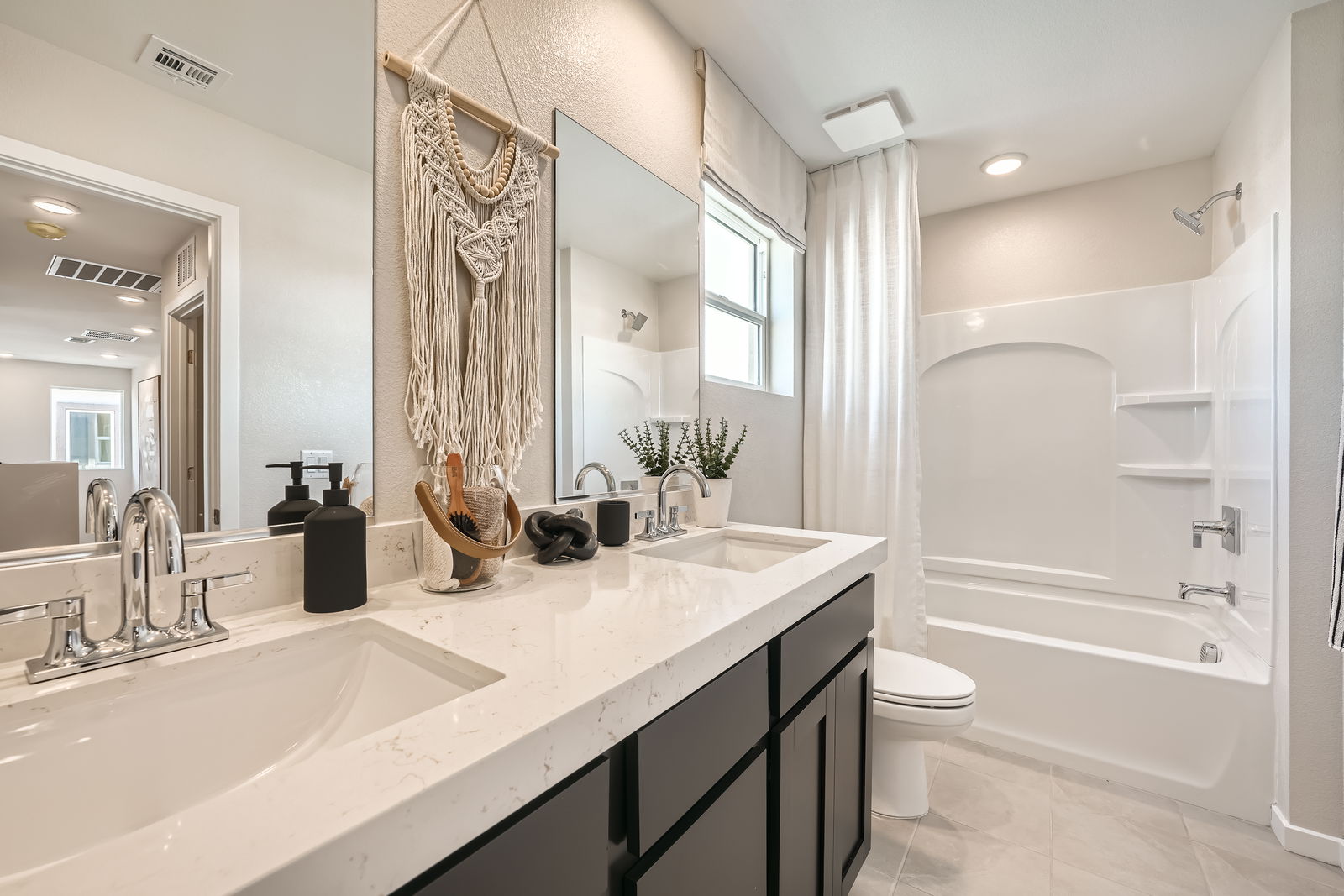 A bathroom with a tub sink and toilet.