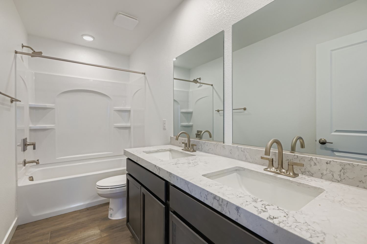 A bathroom with a tub sink and toilet.
