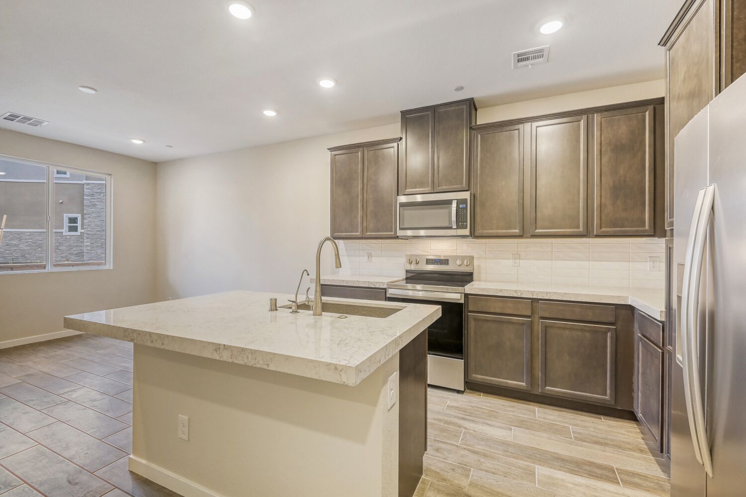 A kitchen with wooden cabinets.