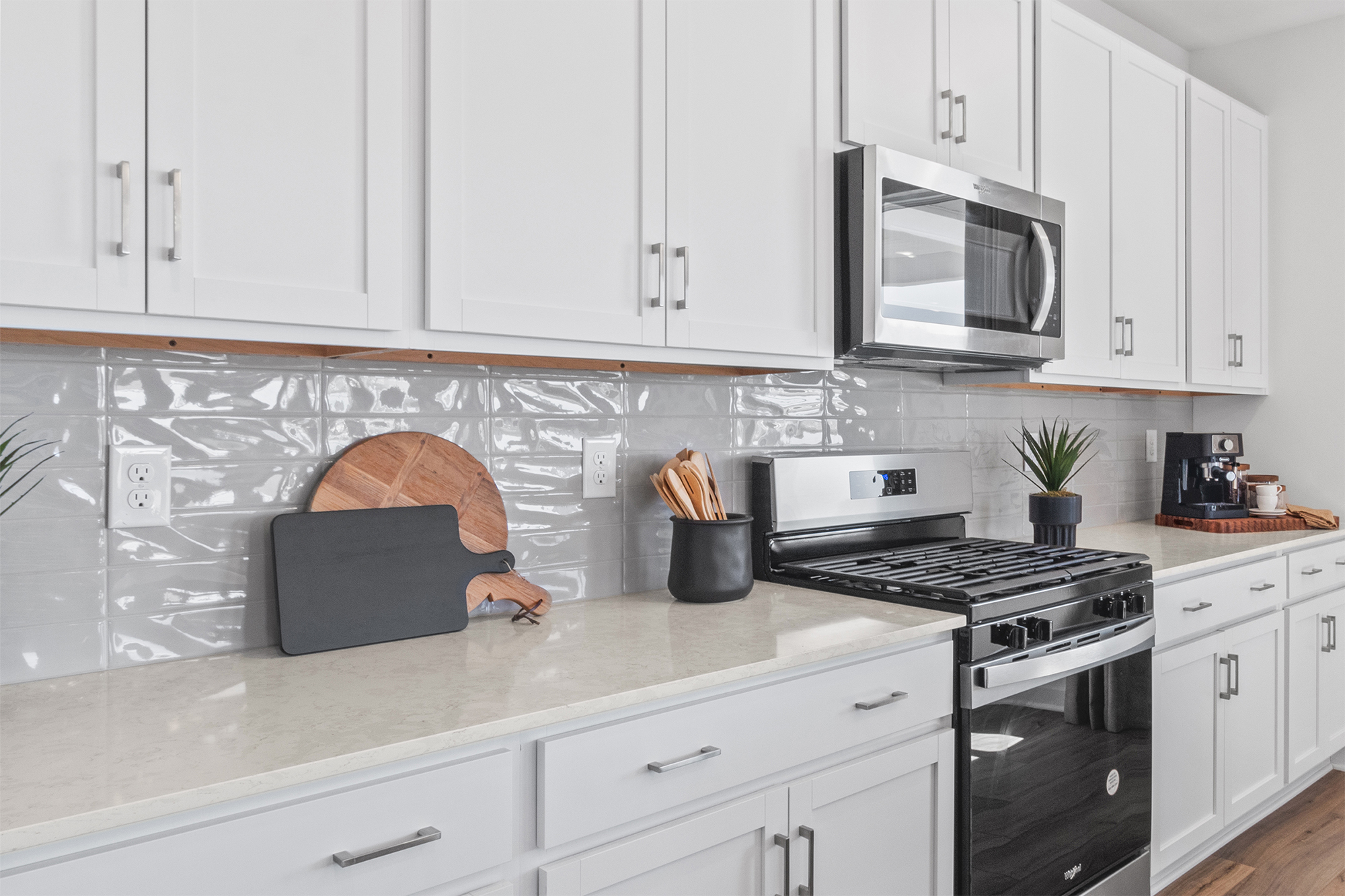 A kitchen with white cabinets.