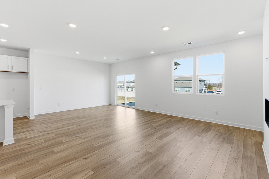 A room with a wood floor and white walls.