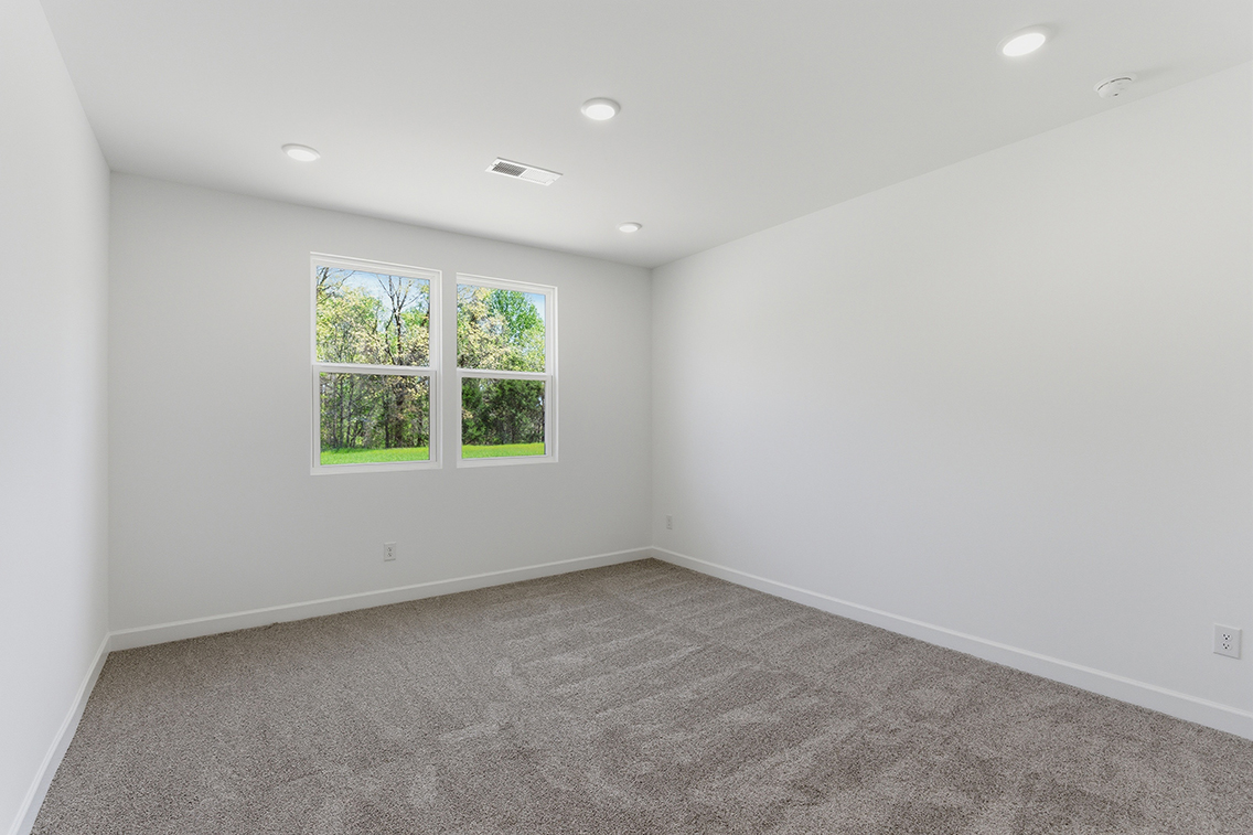 A room with a window and a carpet.