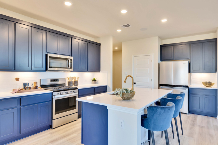 A kitchen with blue cabinets.