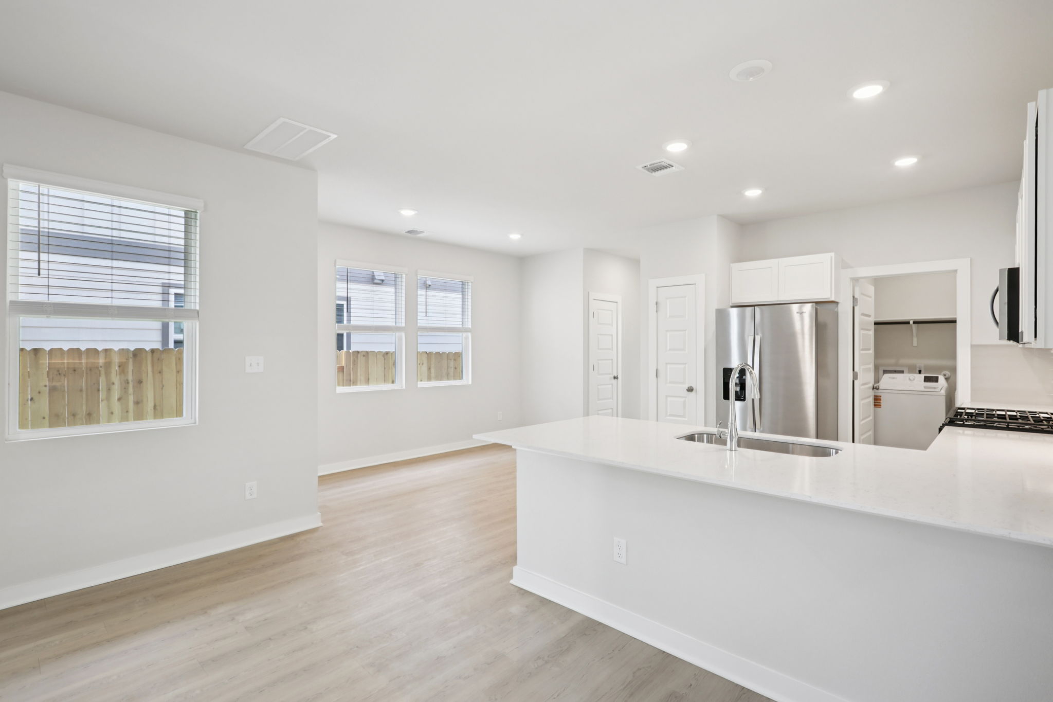 A kitchen with white cabinets.