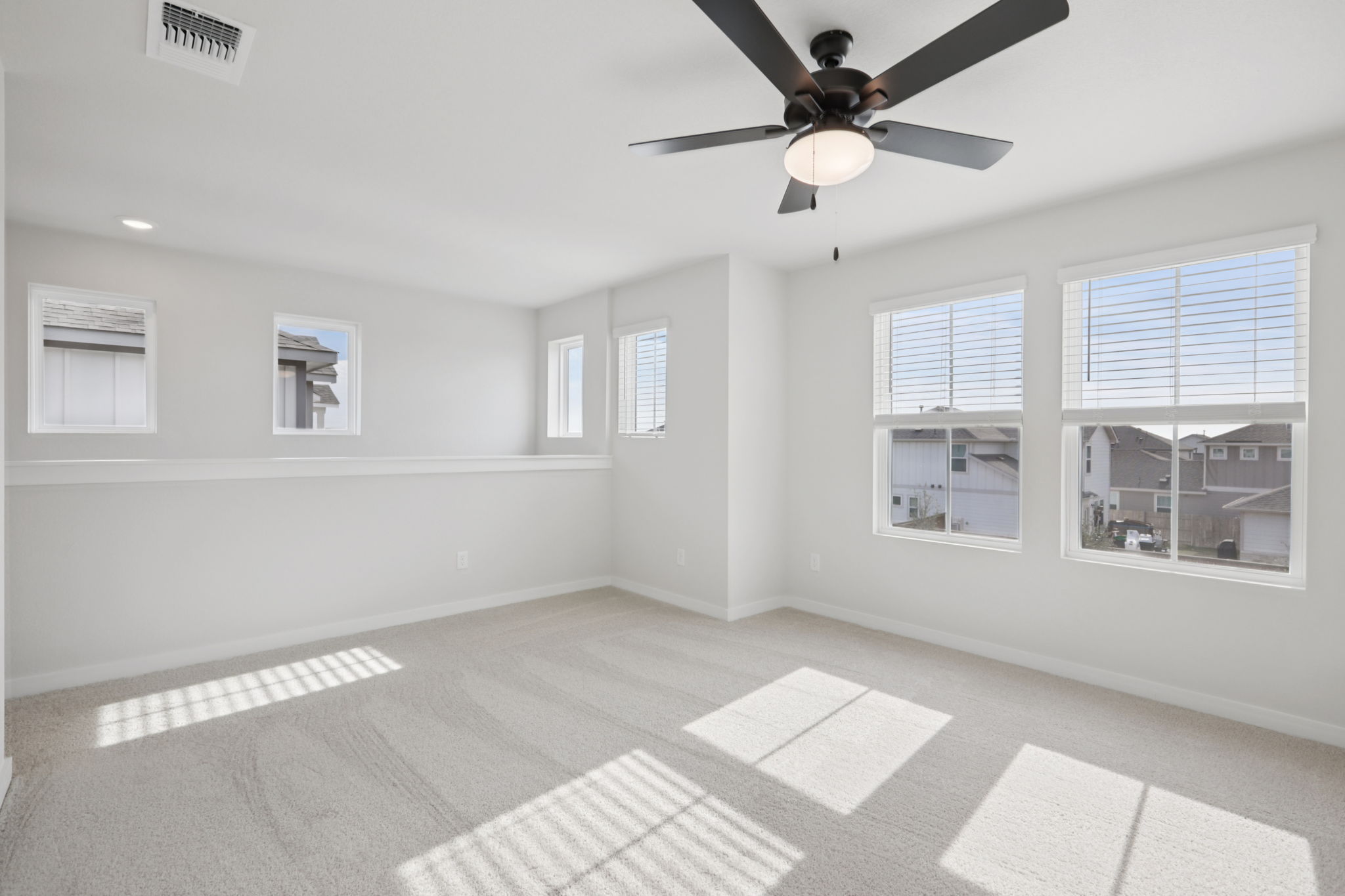 A room with a ceiling fan and a tile floor.
