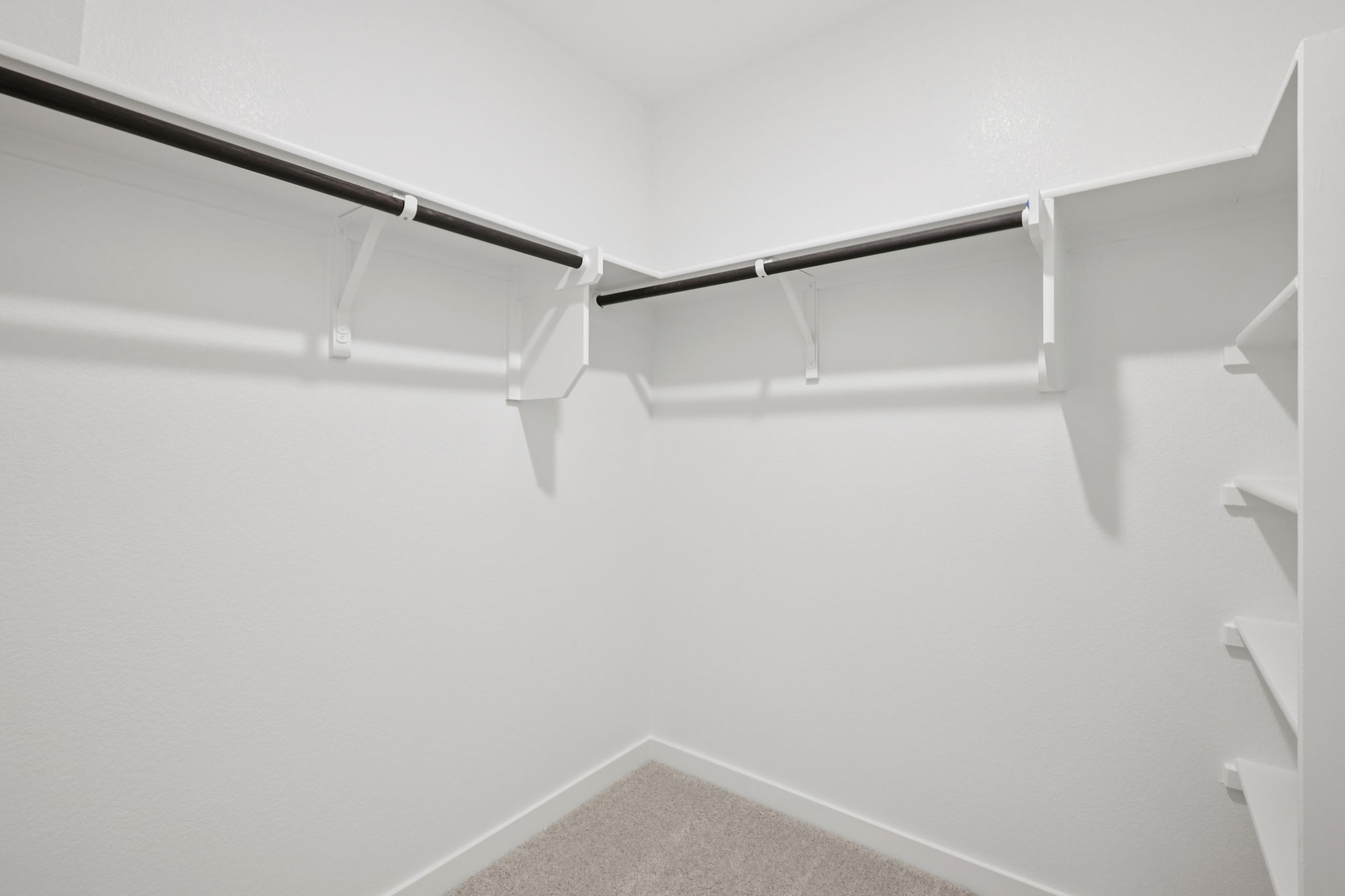 A white staircase with a metal railing.