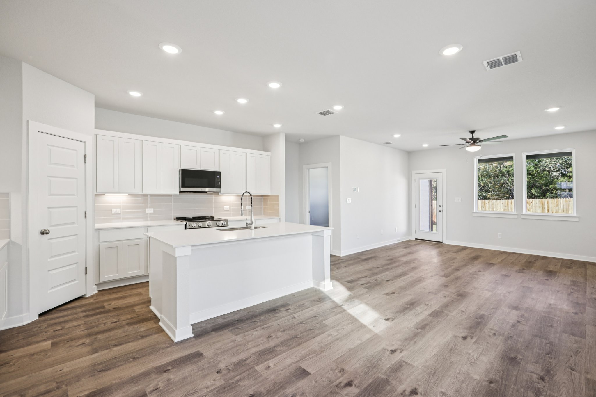 A kitchen with white cabinets.