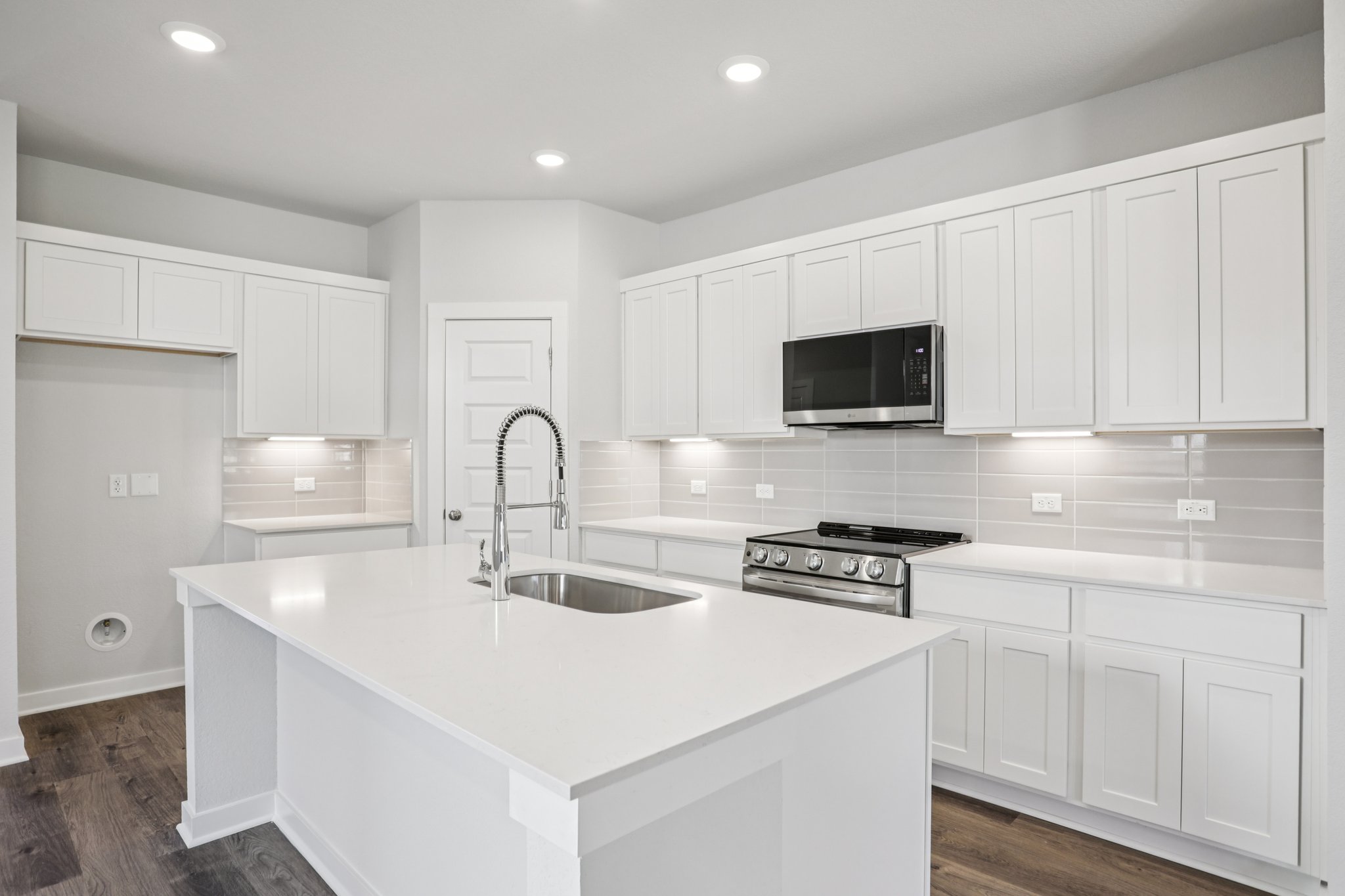 A kitchen with white cabinets.