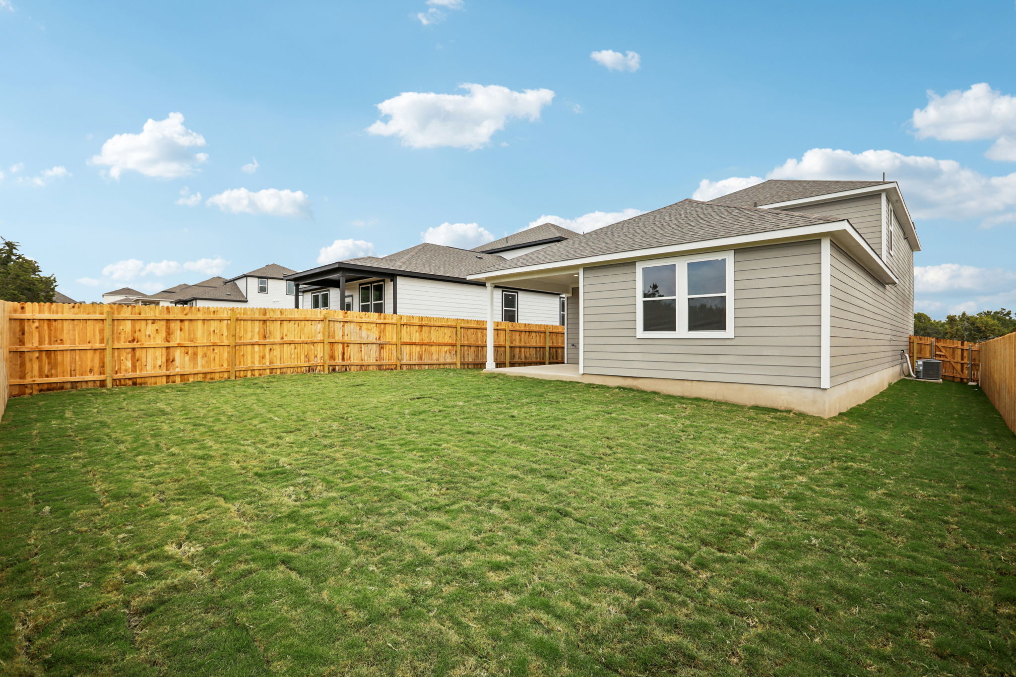 A house with a fence and grass.