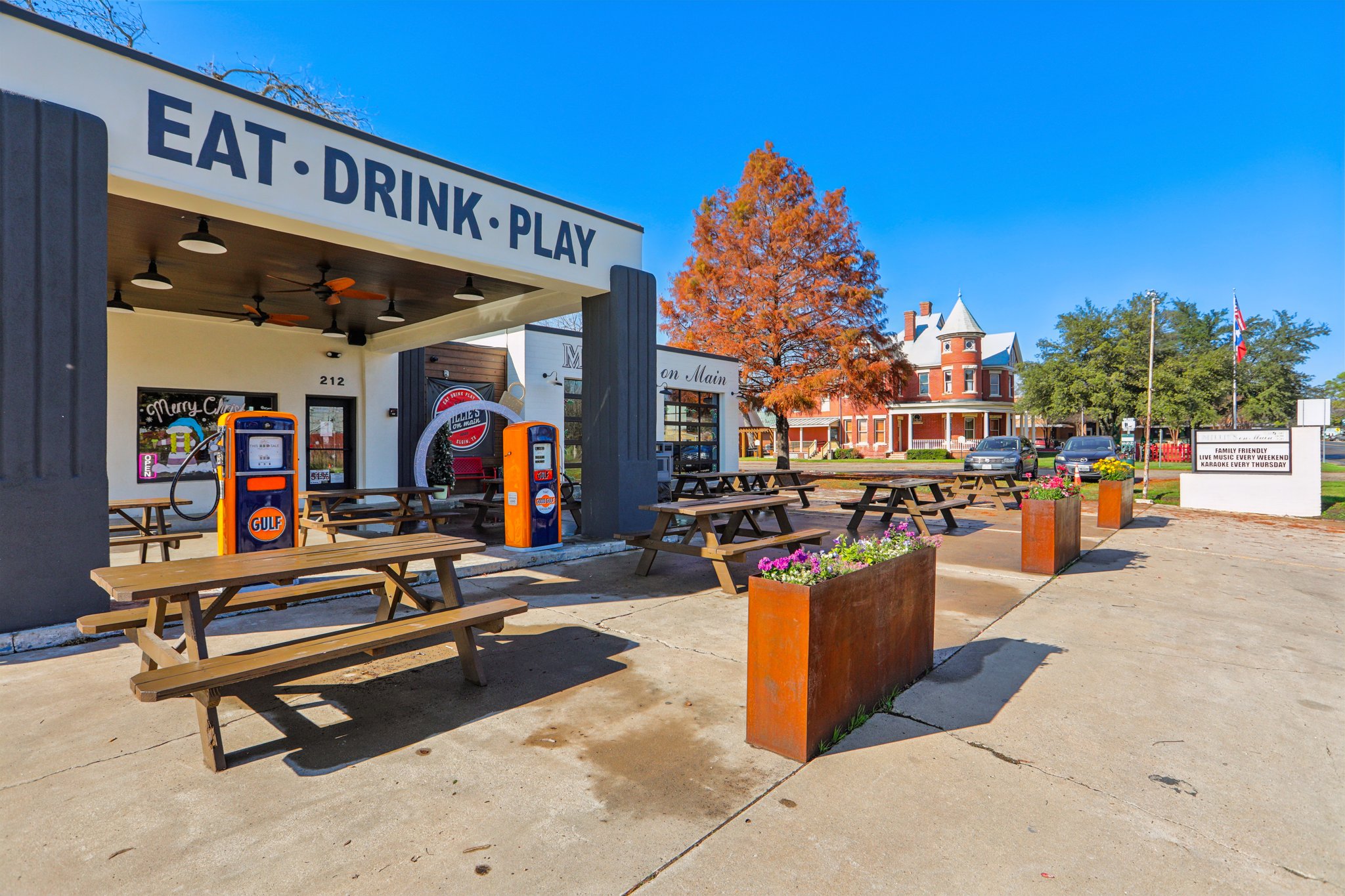 A store front with tables and benches.