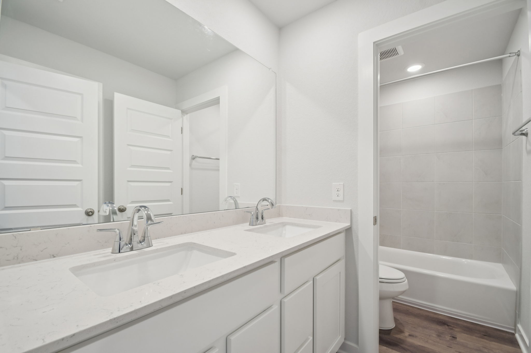 A bathroom with a sink toilet and bathtub.