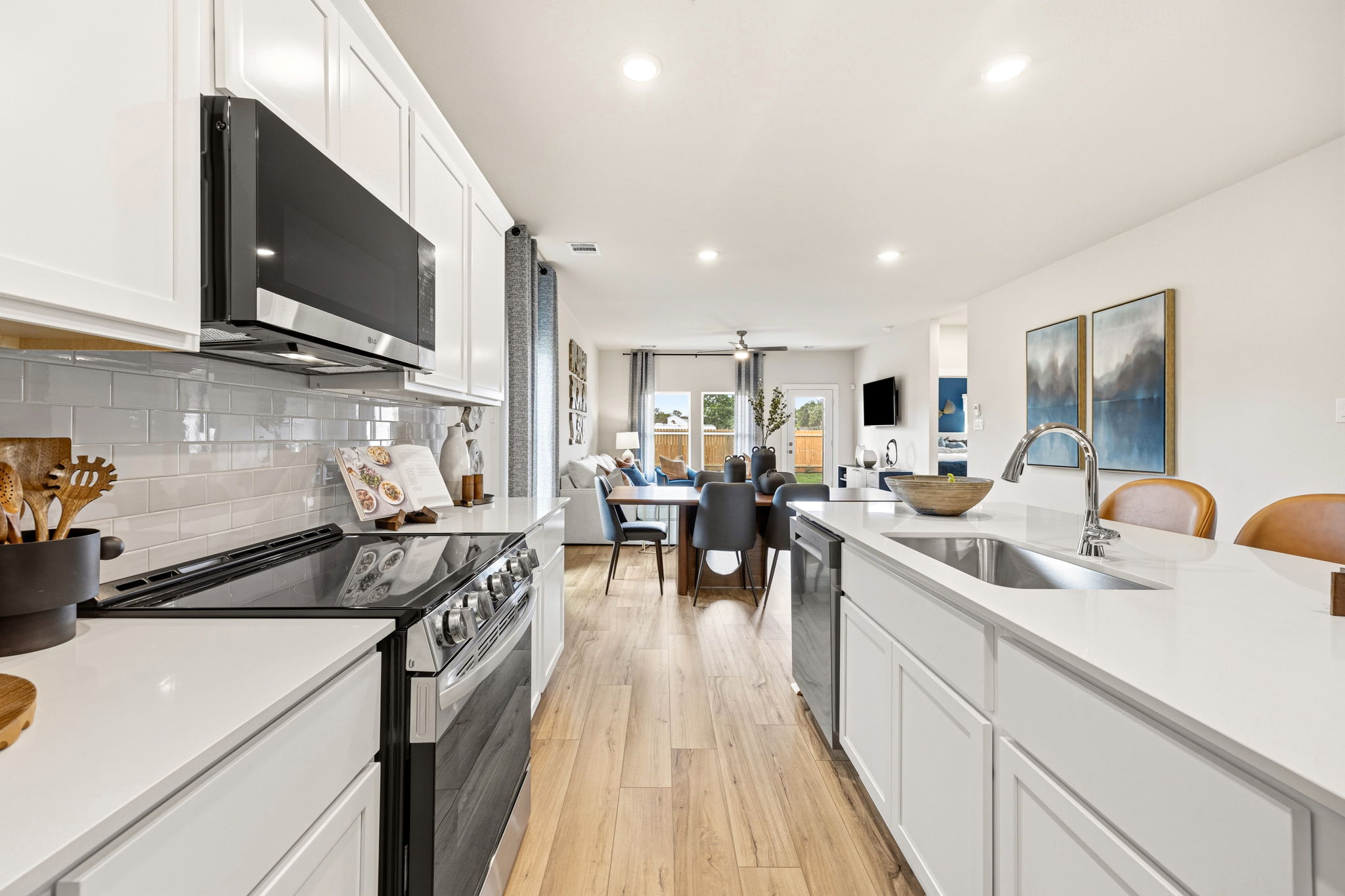 A kitchen with white cabinets.