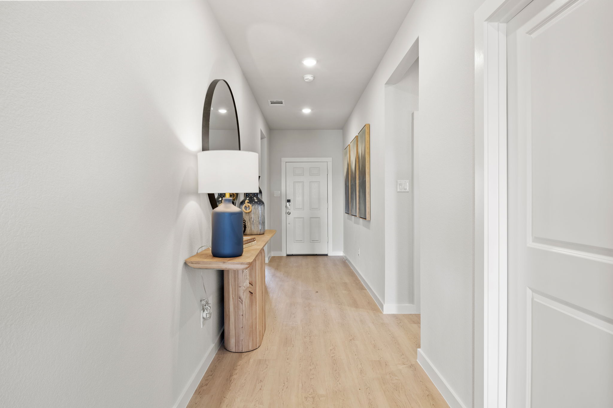 A room with a table and a lamp.