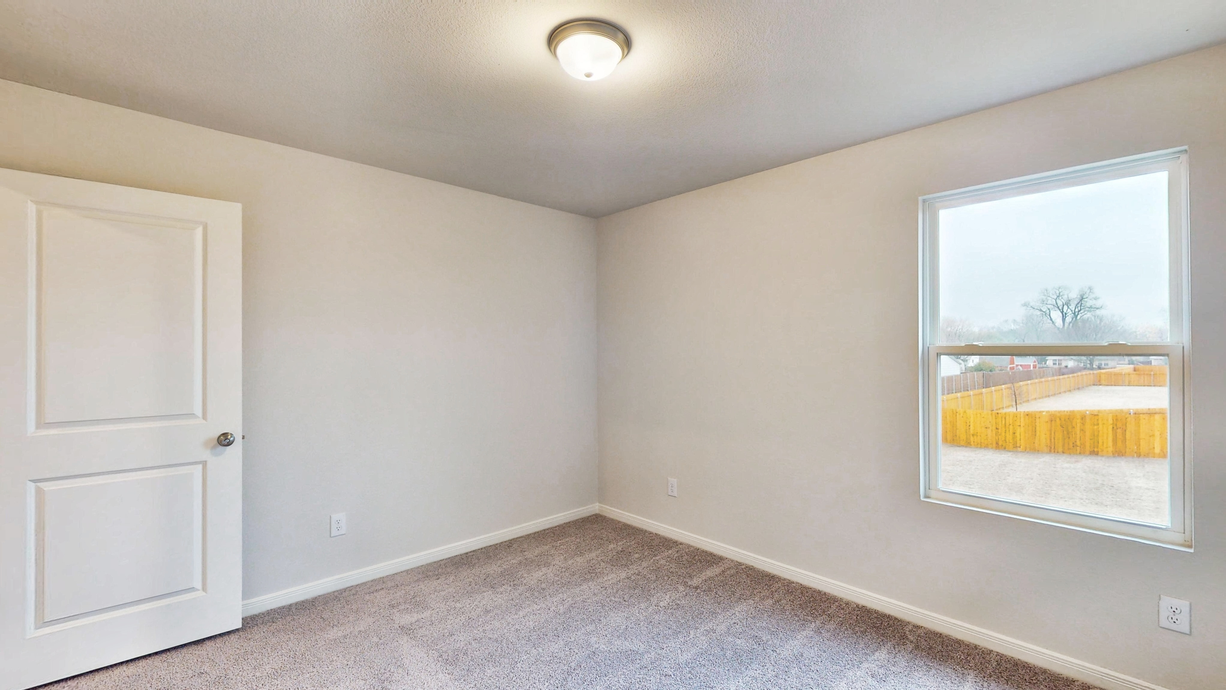 A room with a window and a door.