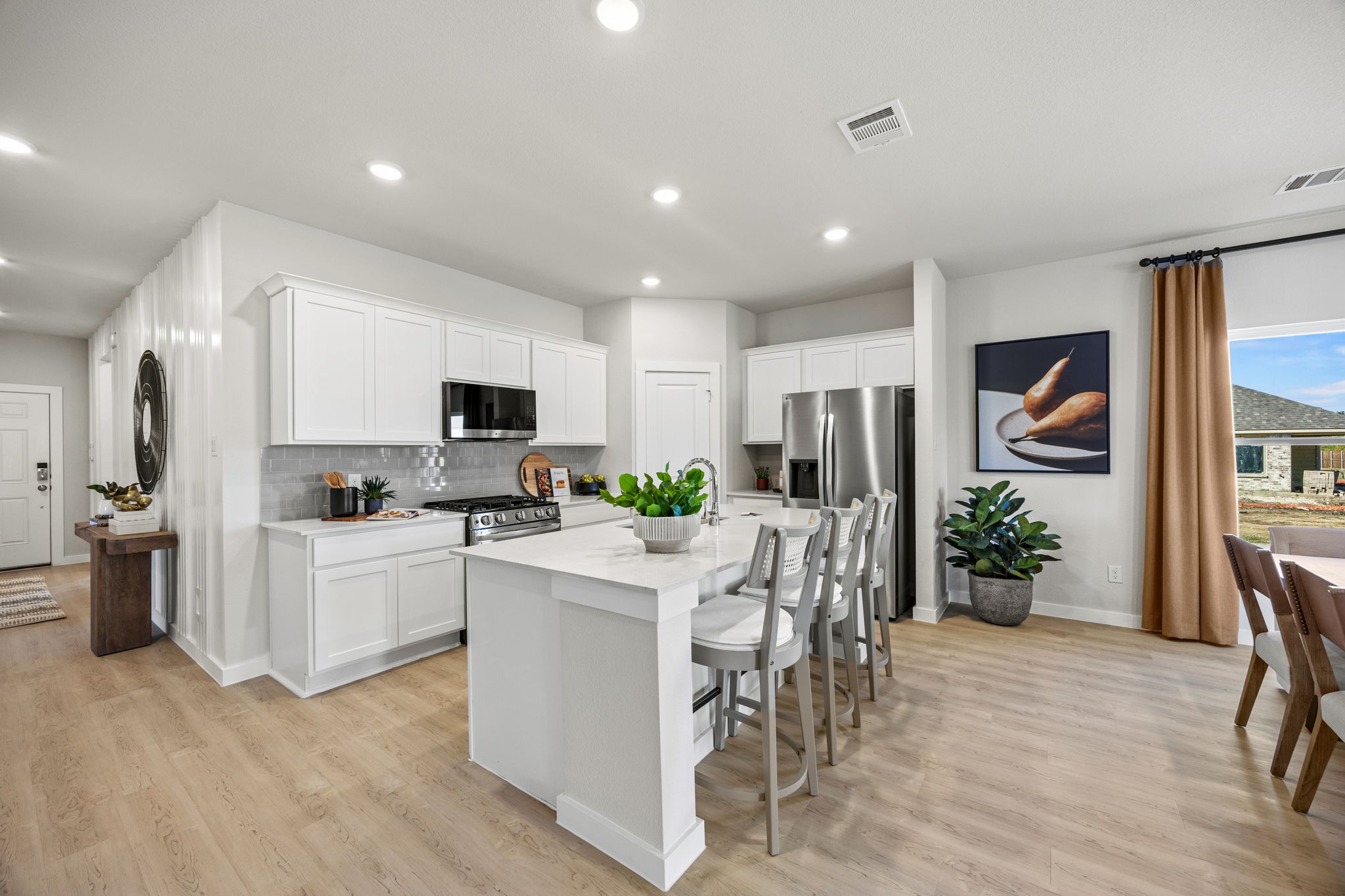 A kitchen with white cabinets.