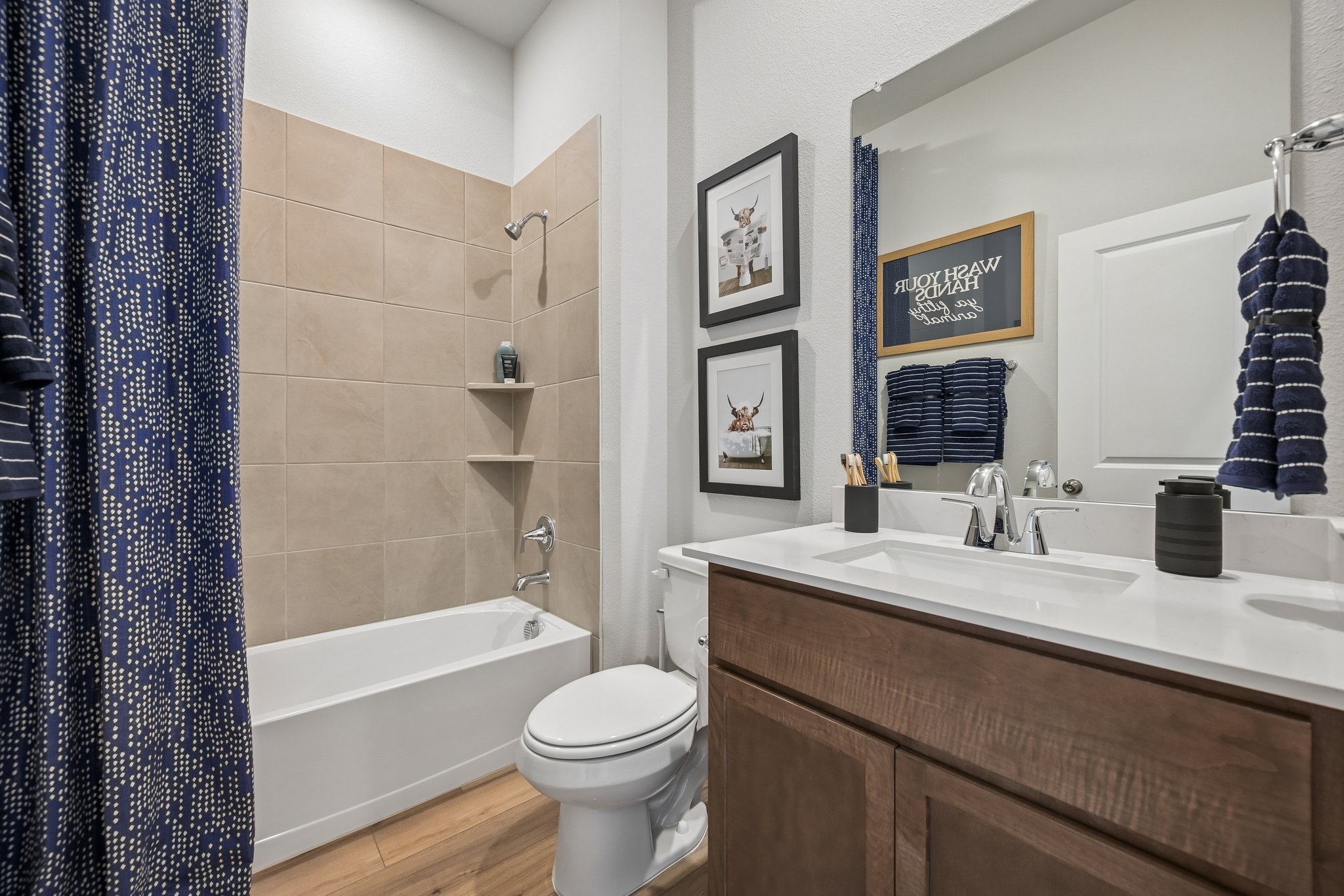 A bathroom with a tub sink and toilet.