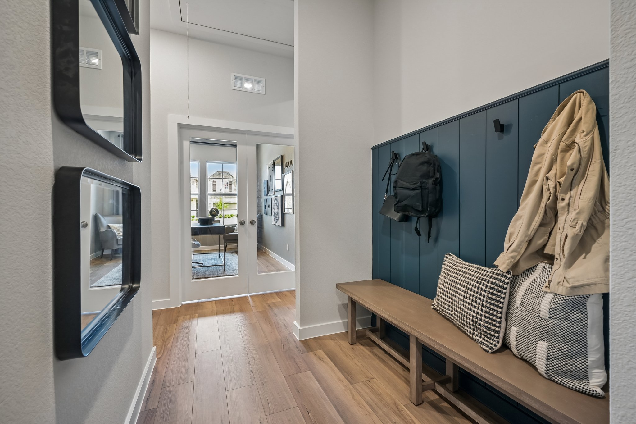 A room with a bench and a mirror.