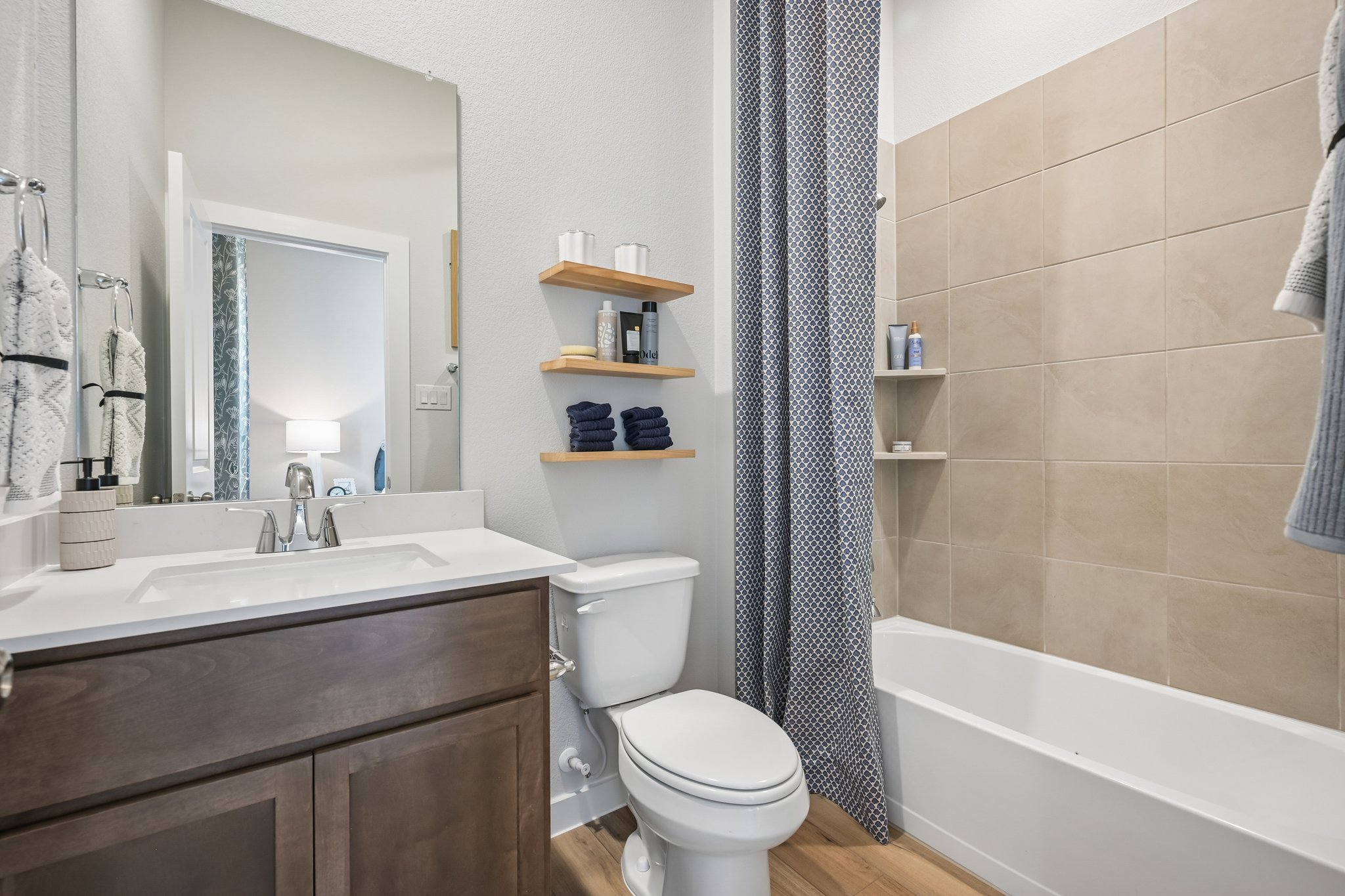 A bathroom with a tub toilet and sink.