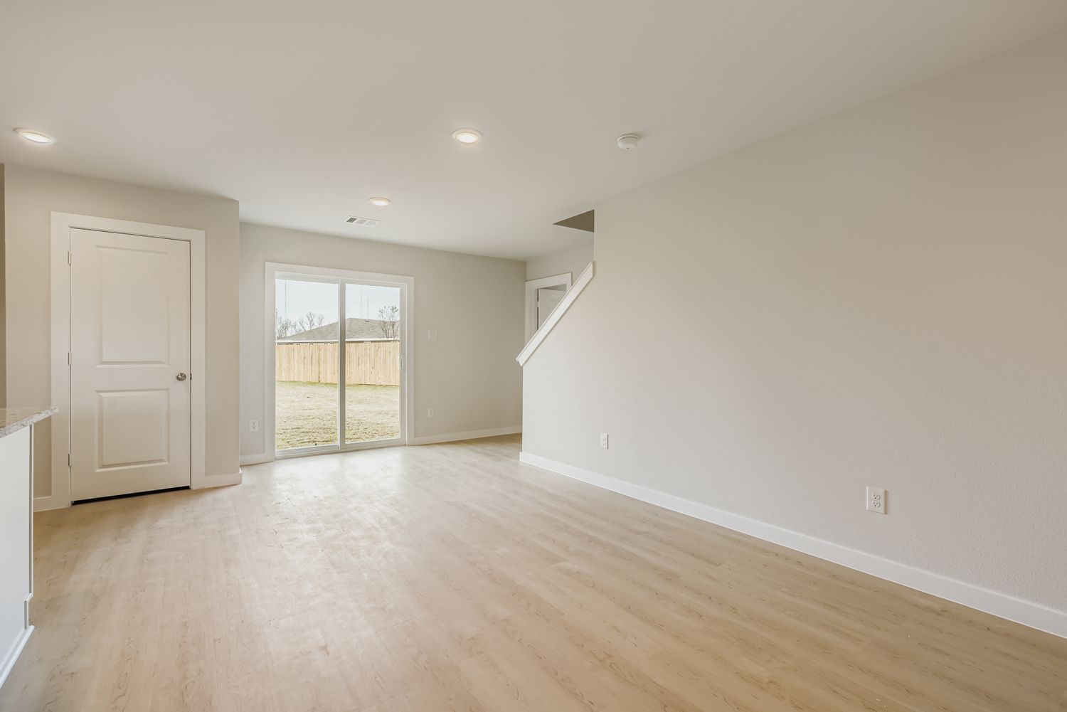 A room with a wood floor and white walls.
