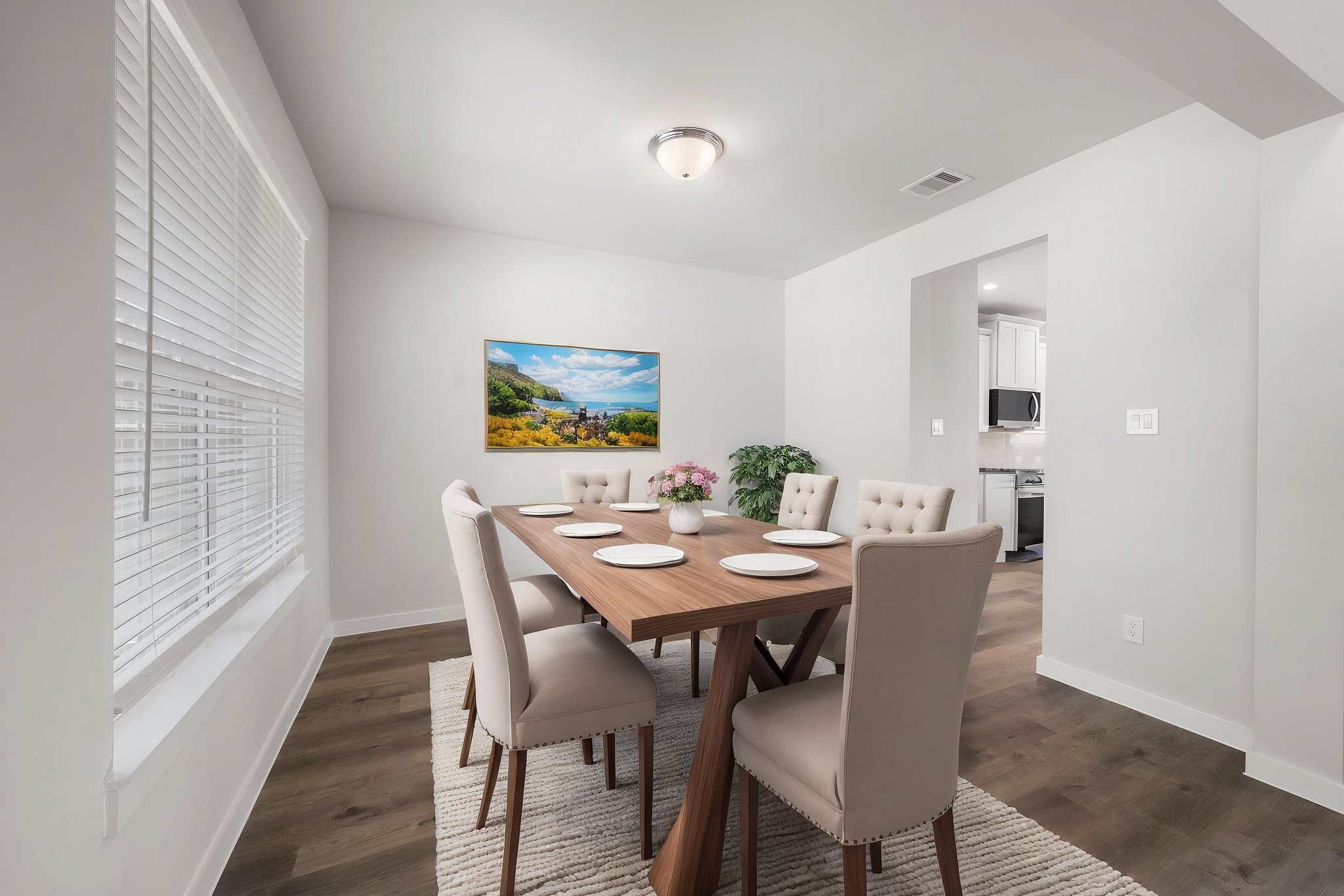A dining room with a table and chairs.