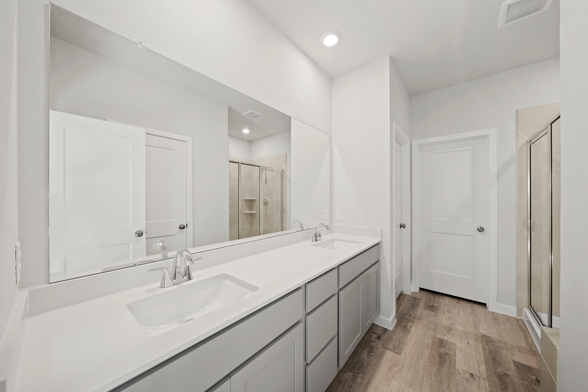 A bathroom with a large mirror.