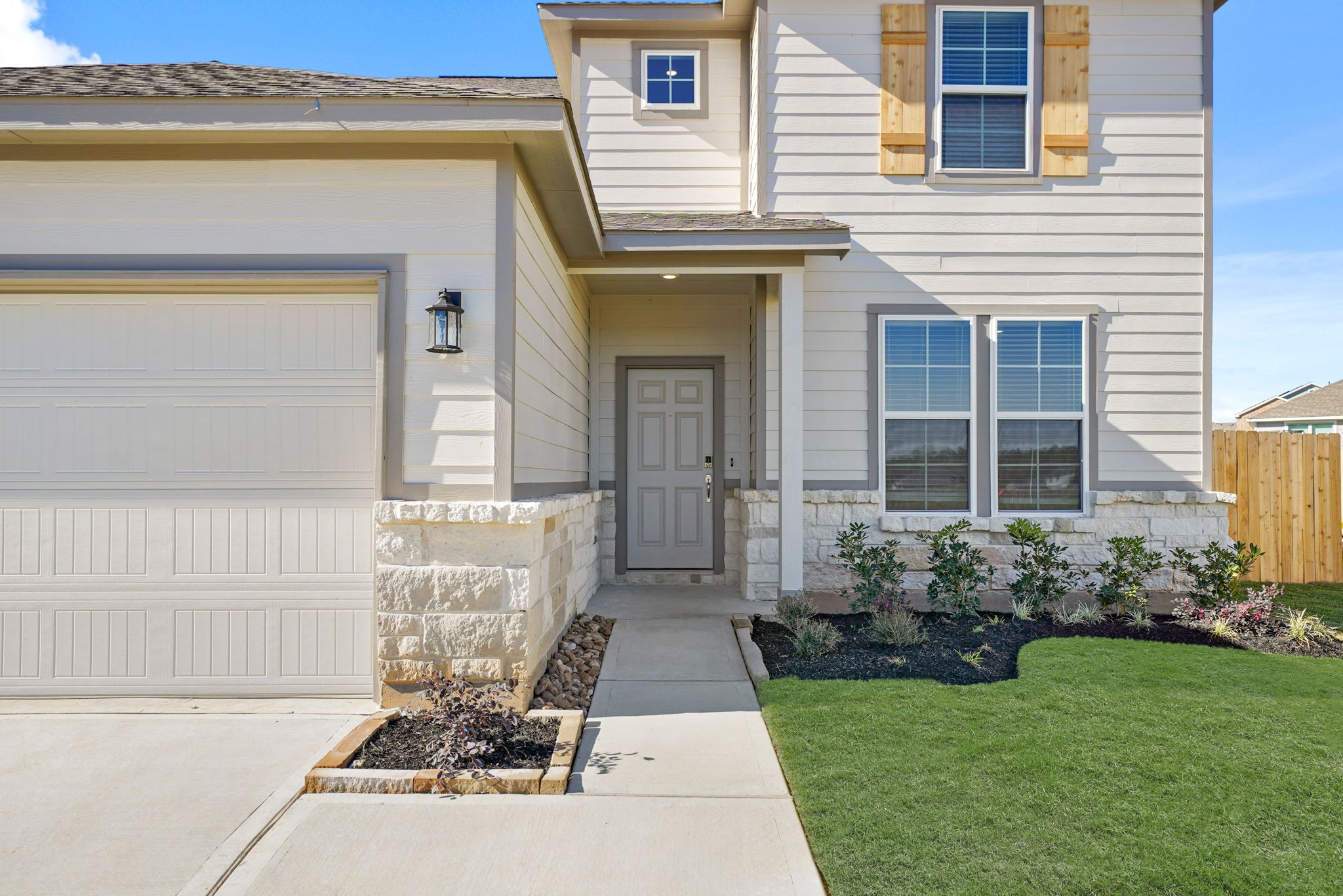 A house with a garage and a lawn.