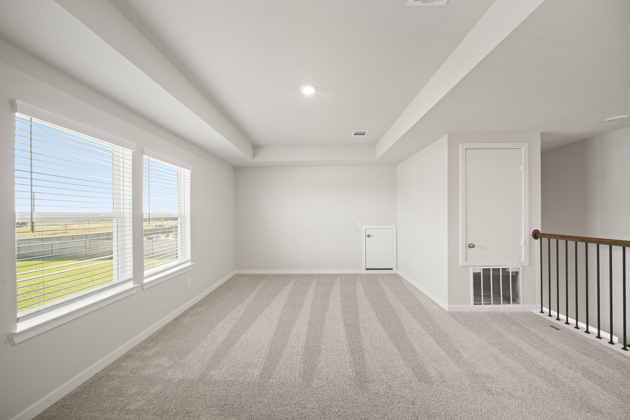 A large empty room with a window.