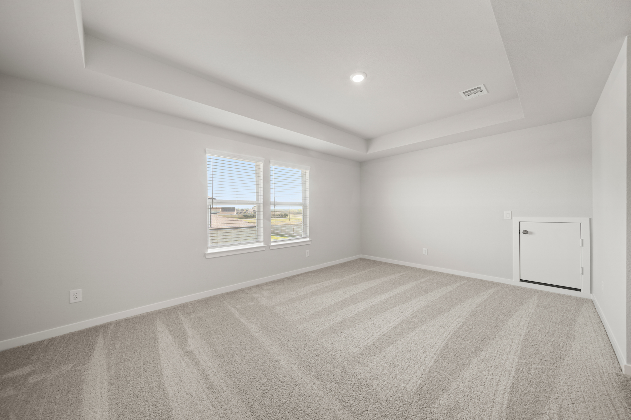 A room with a bed and a window.