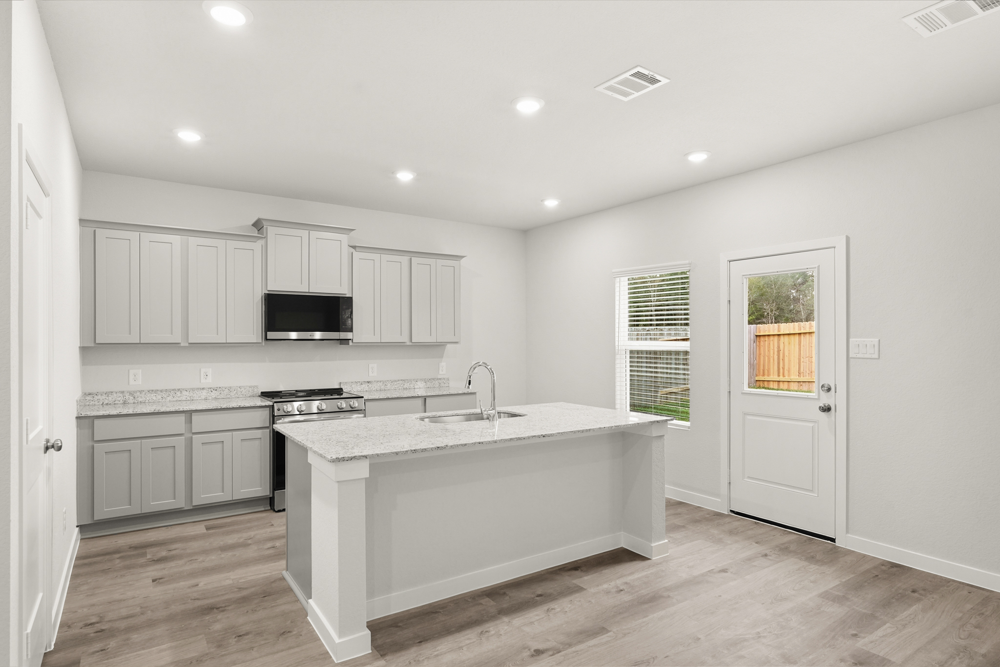 A kitchen with white cabinets.