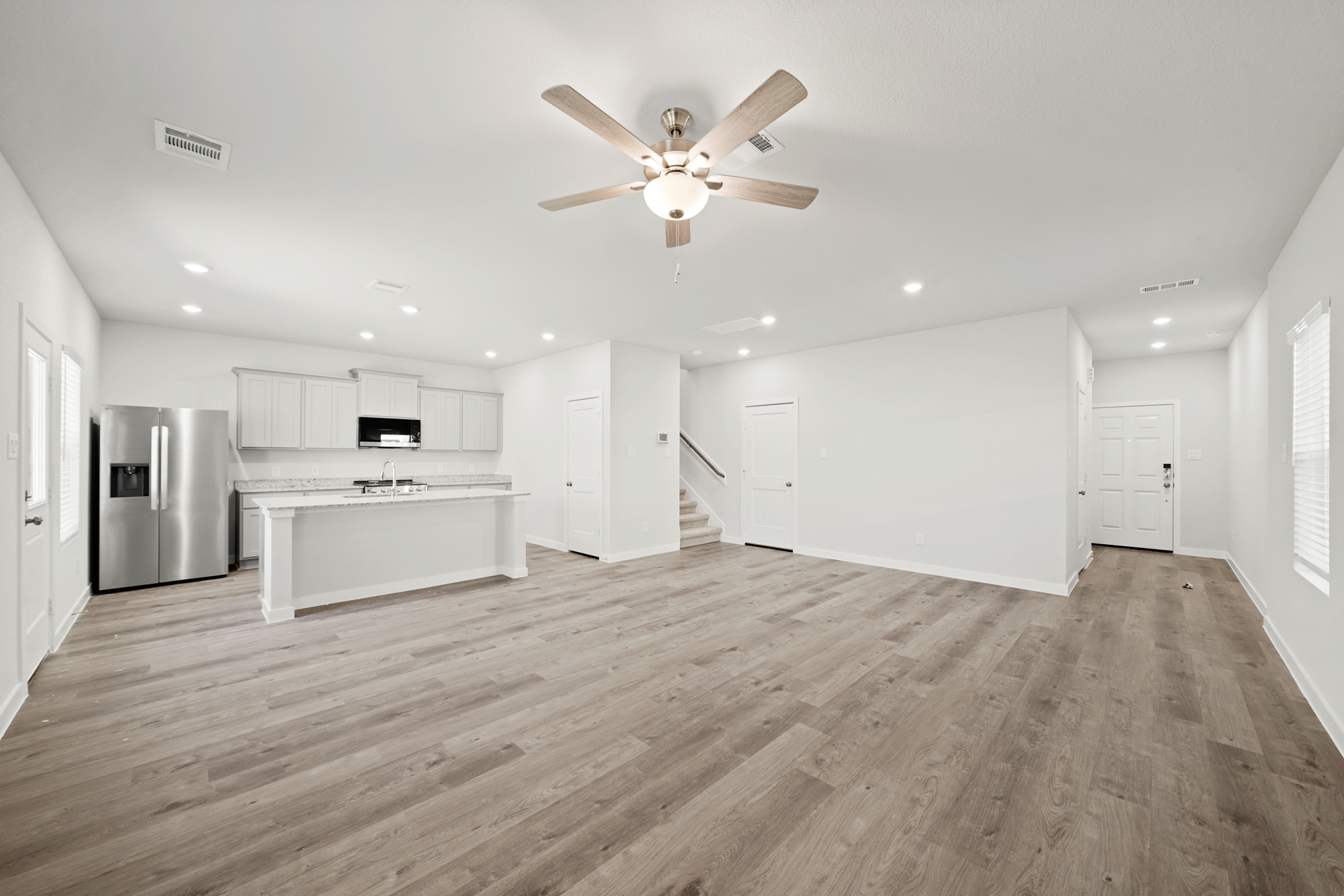 A large kitchen with white cabinets.