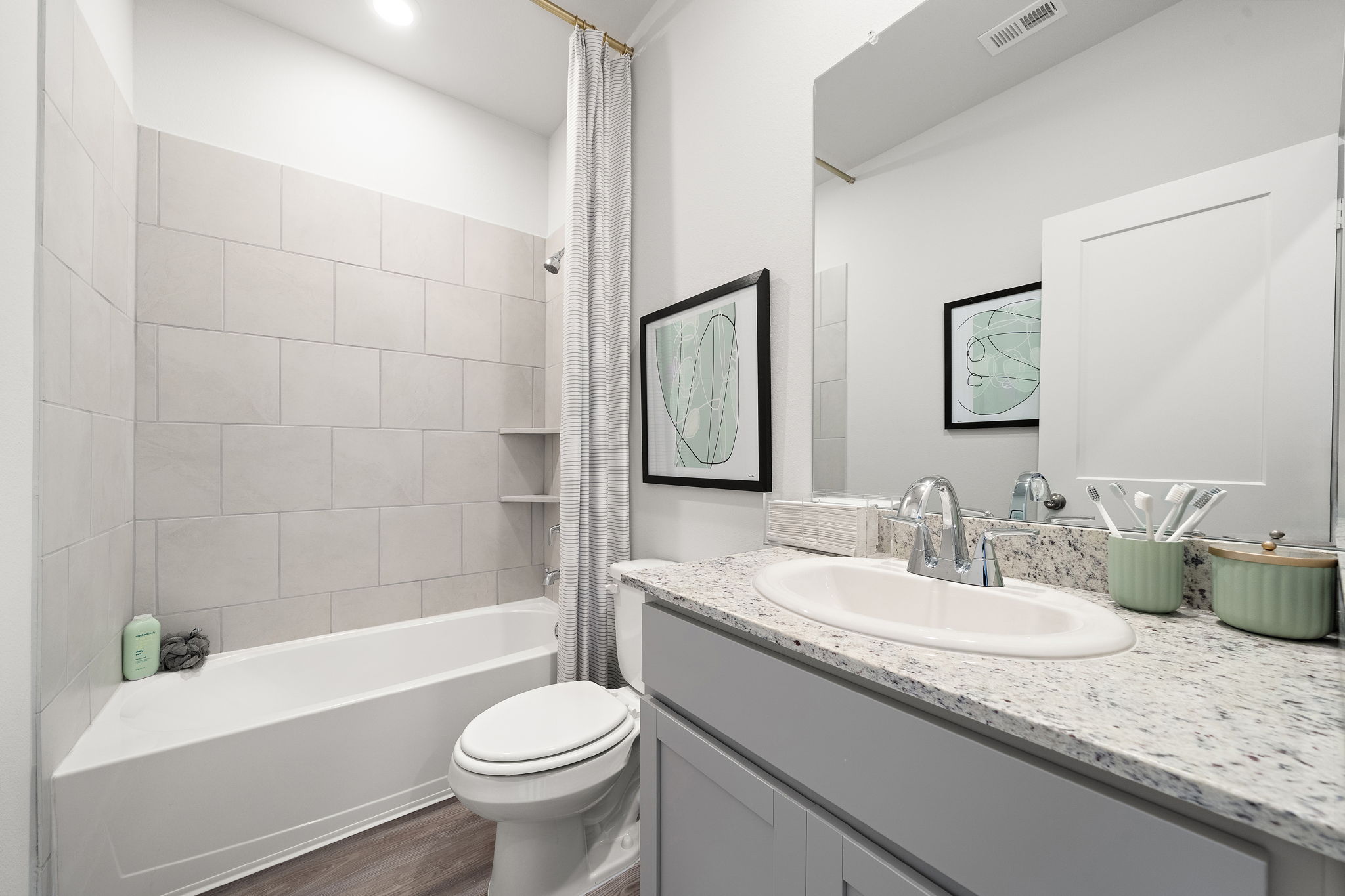 A bathroom with a tub sink and toilet.